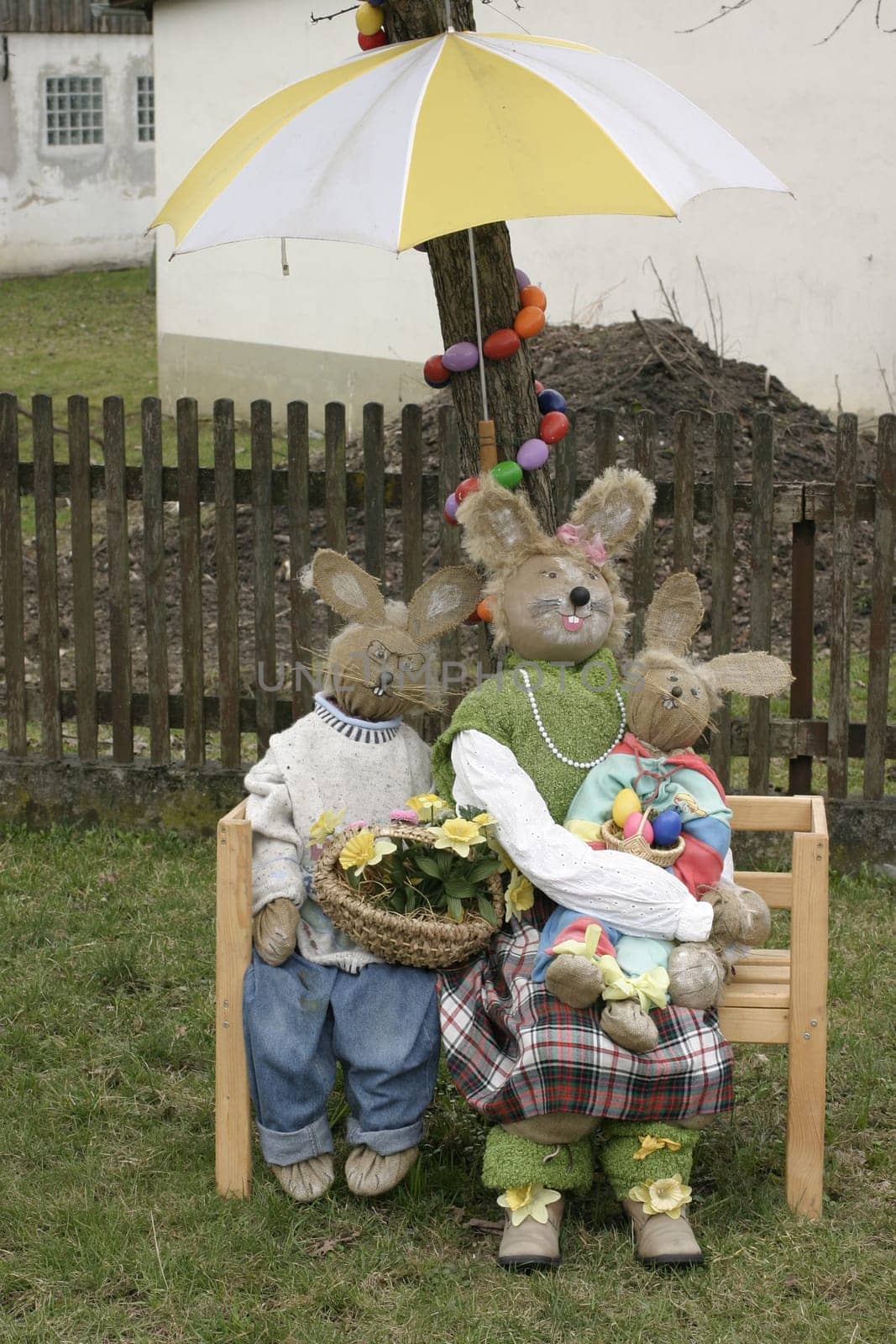 Easter bunny family made of straw with umbrella