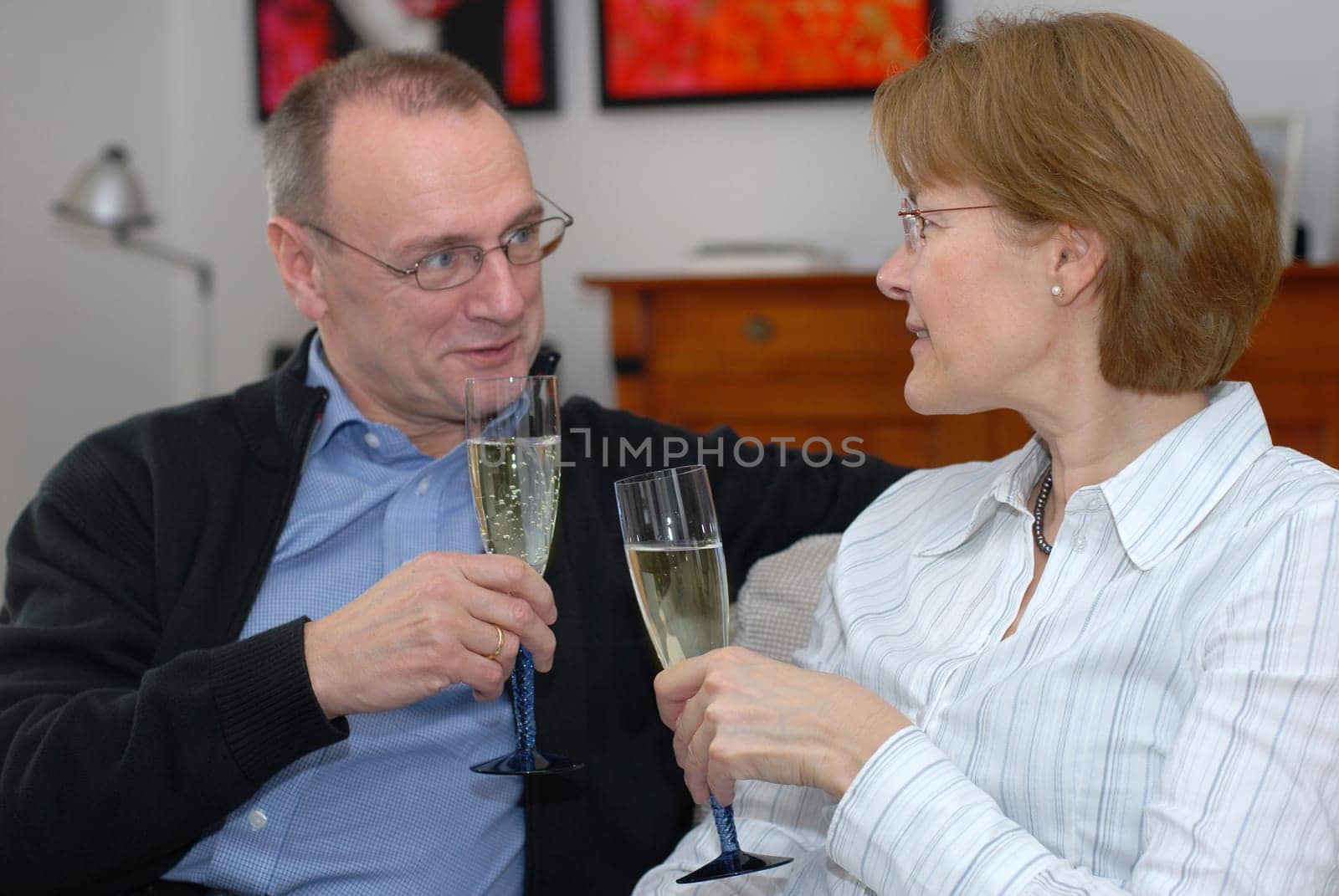 Middle-aged couple with champagne glasses