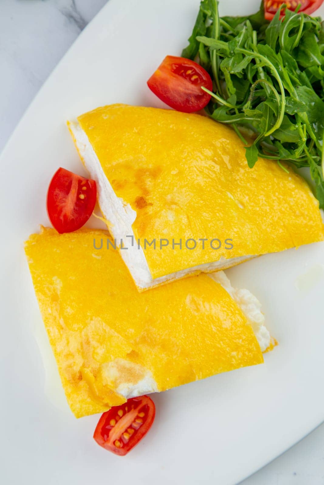 French tall omelette with arugula and cherry tomatoes