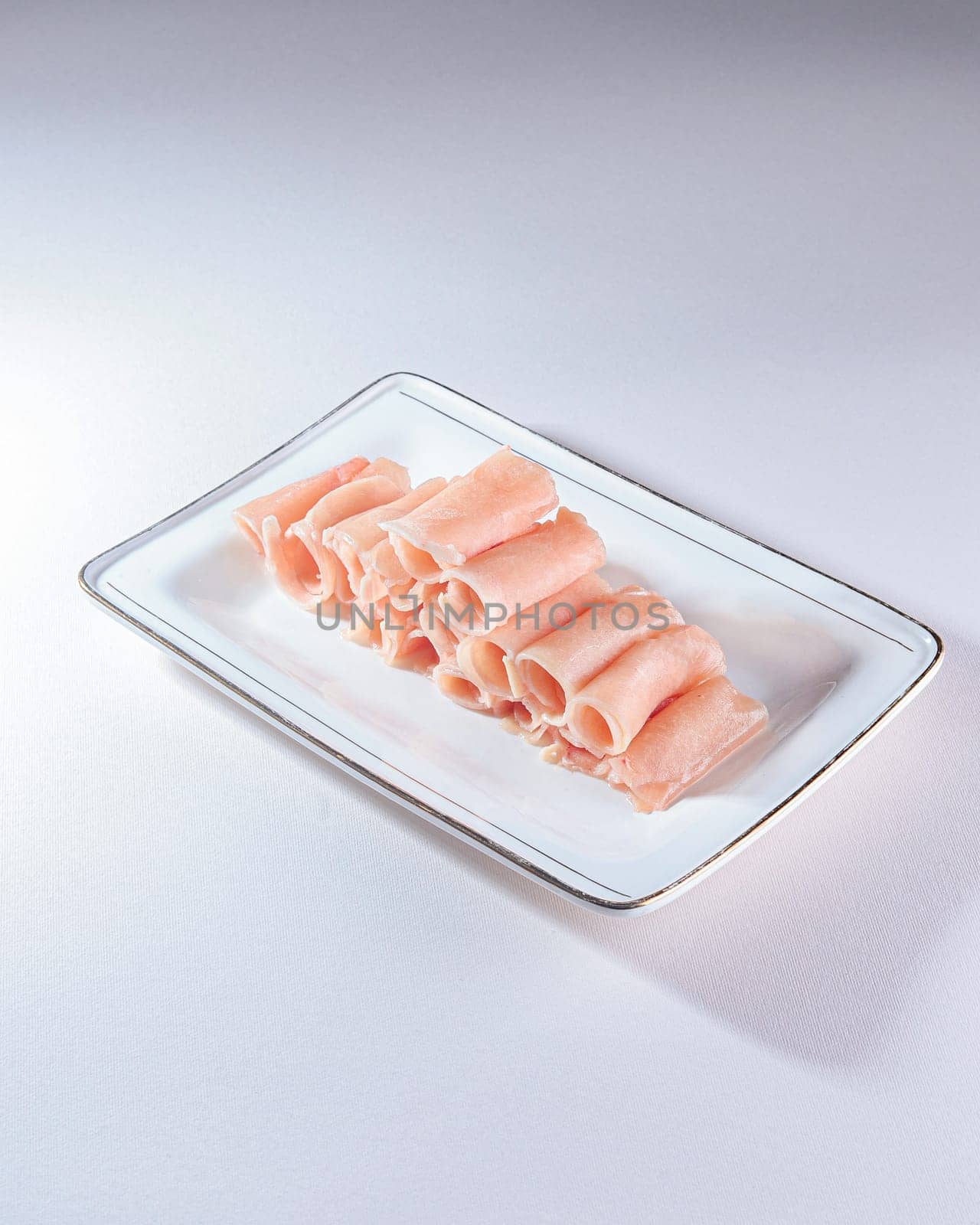 fresh and raw pork rolls on a white background by tewolf