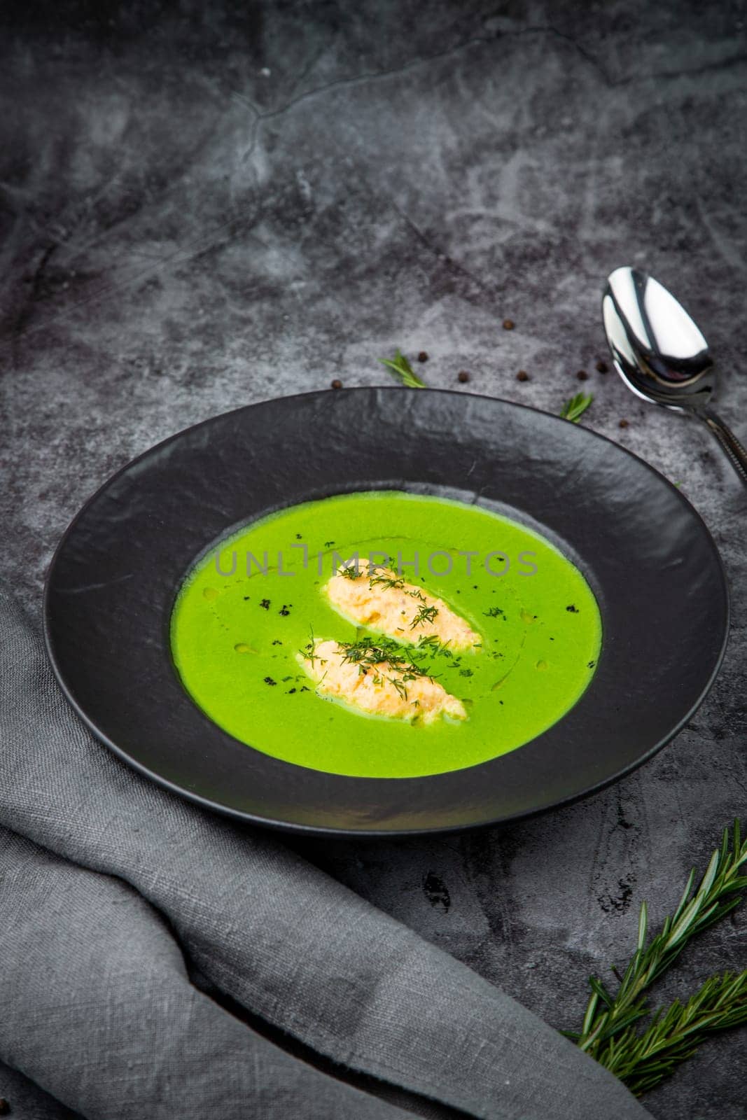 broccoli cream soup with pieces of chicken fillet on a dark background by tewolf