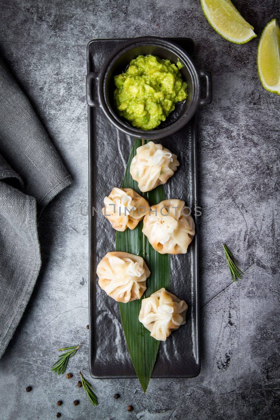 khinkali is a steamed Georgian dish of dough and ground beef. National cuisine, dark background by tewolf