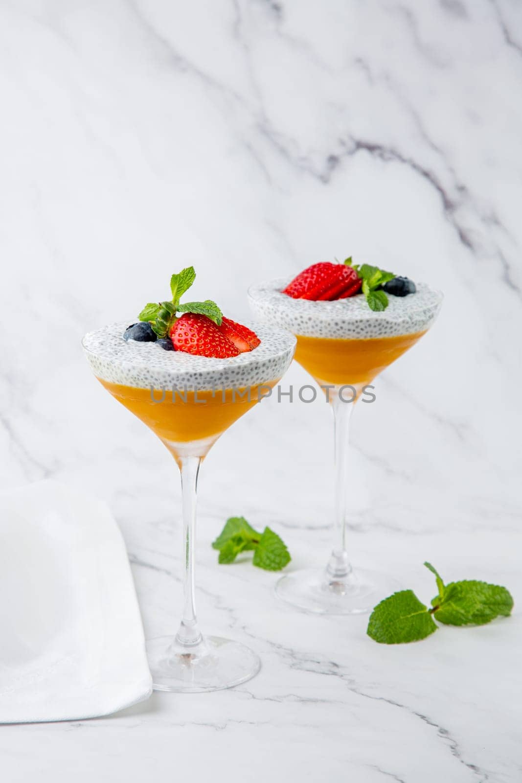 exotic fruit cocktails with berries and chia seed topping and mint