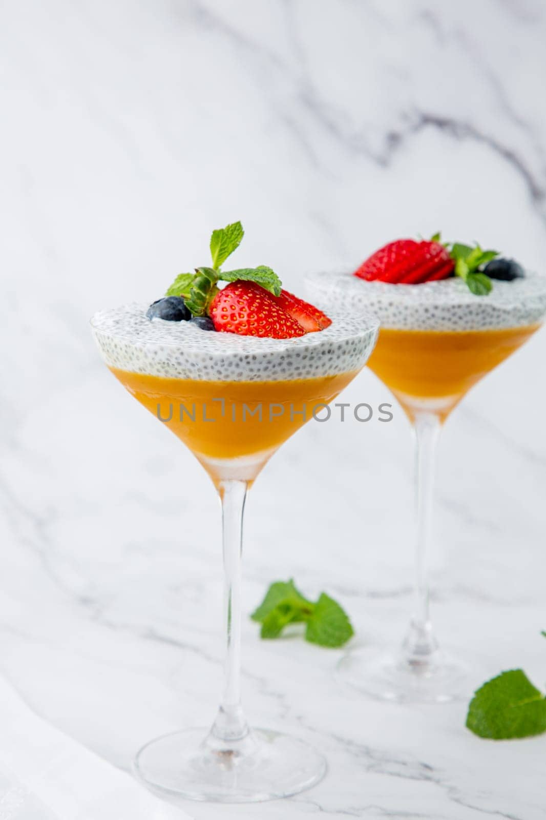 exotic fruit cocktails with berries and chia seed topping and mint