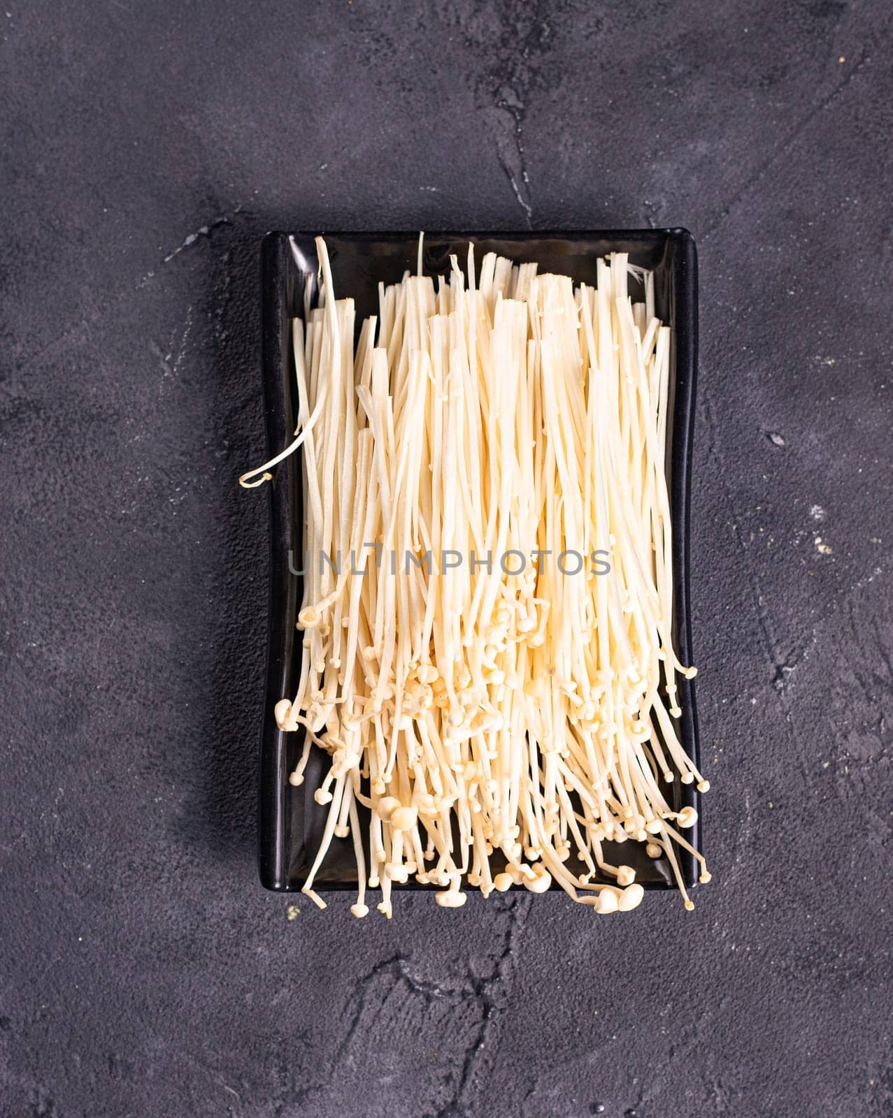 enoki mushrooms called golden needle. Garnish. View from above. Chinese cuisine, hotpot ingredient