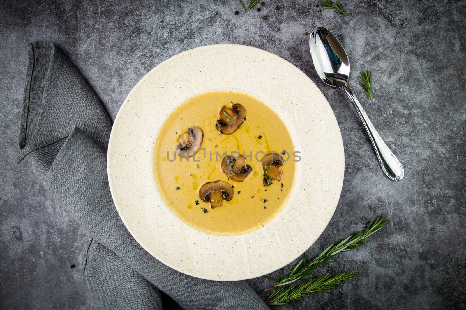 mushroom soup puree with champignons in a white plate top view by tewolf