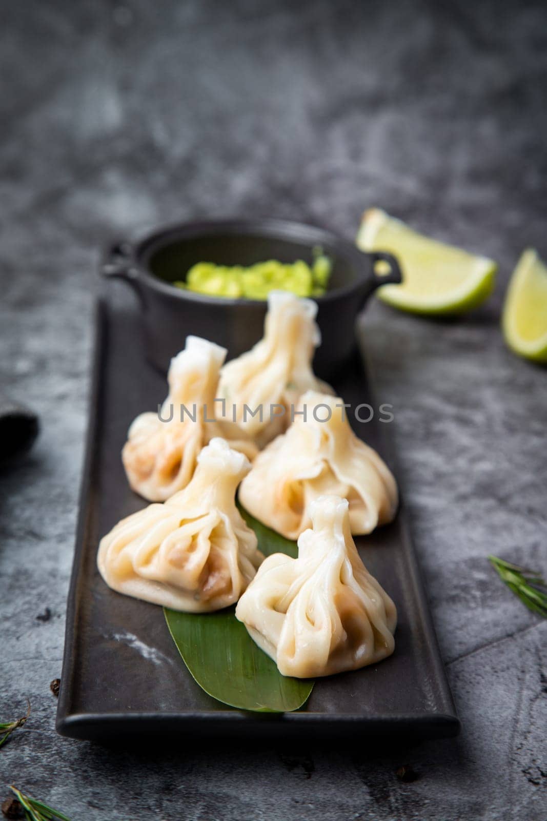 khinkali is a steamed Georgian dish of dough and ground beef. National cuisine, dark background by tewolf