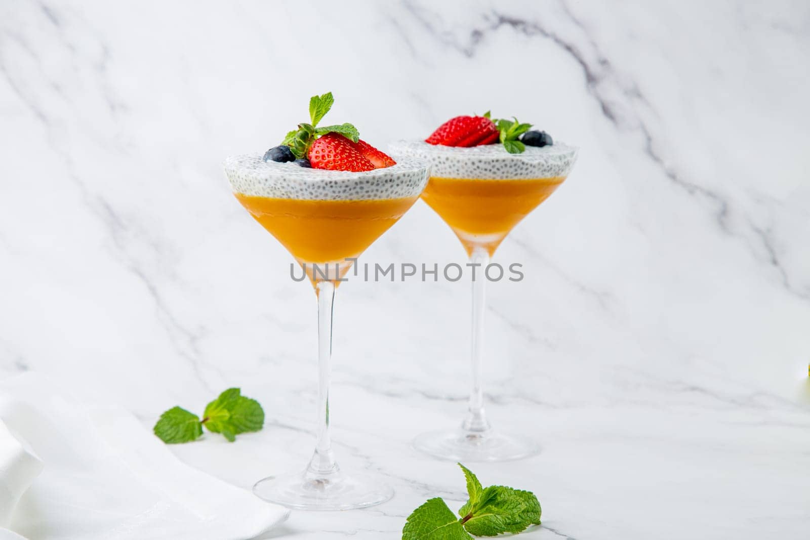 exotic fruit cocktails with berries and chia seed topping and mint