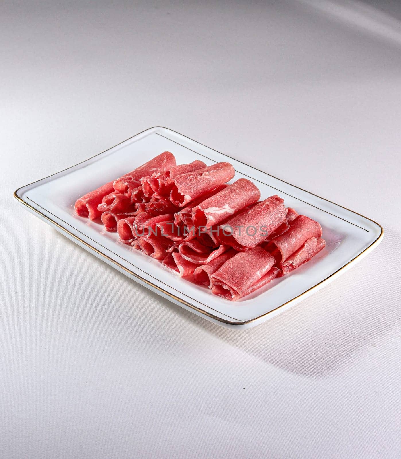 fresh and raw pork rolls on a white background by tewolf