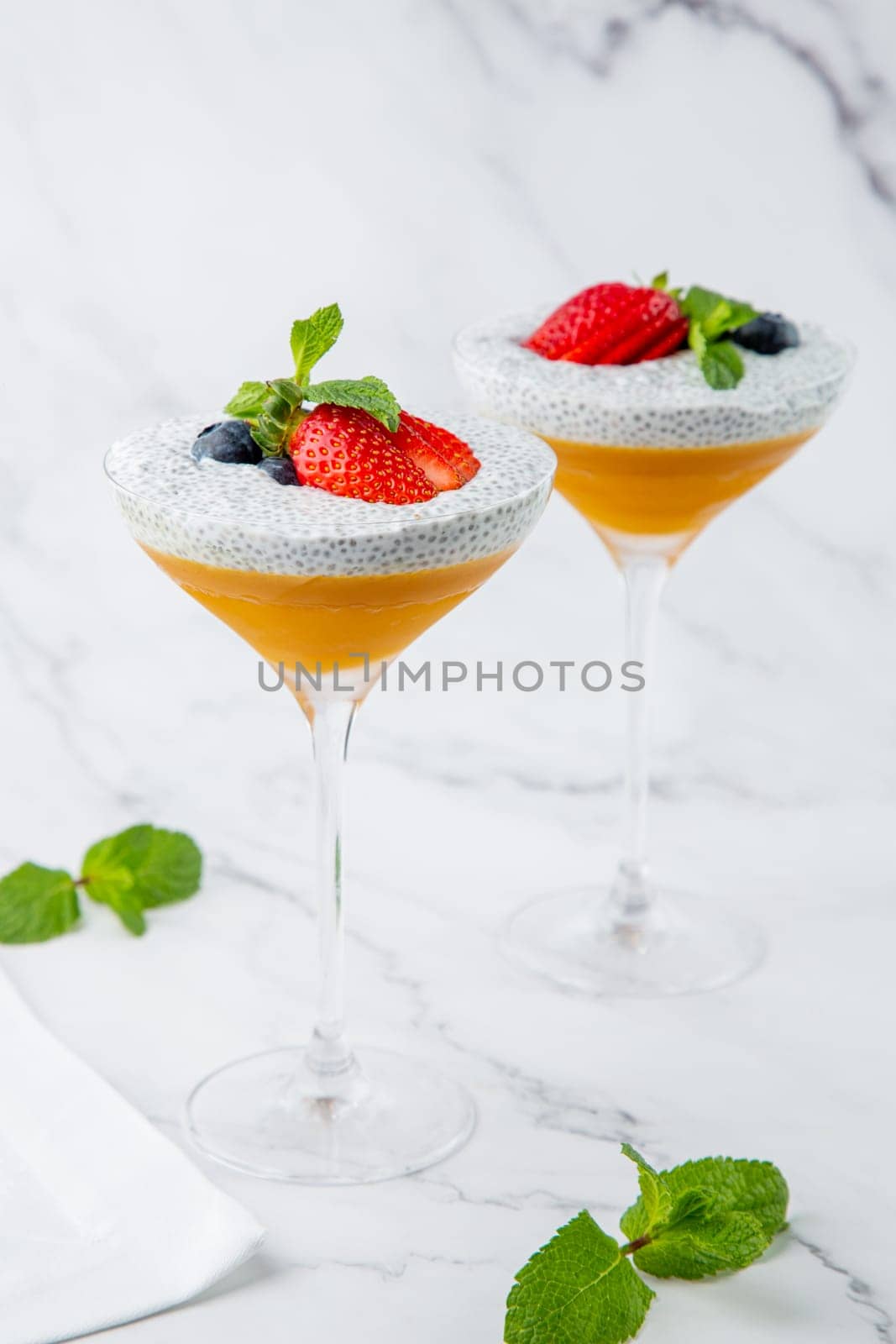 exotic fruit cocktails with berries and chia seed topping and mint