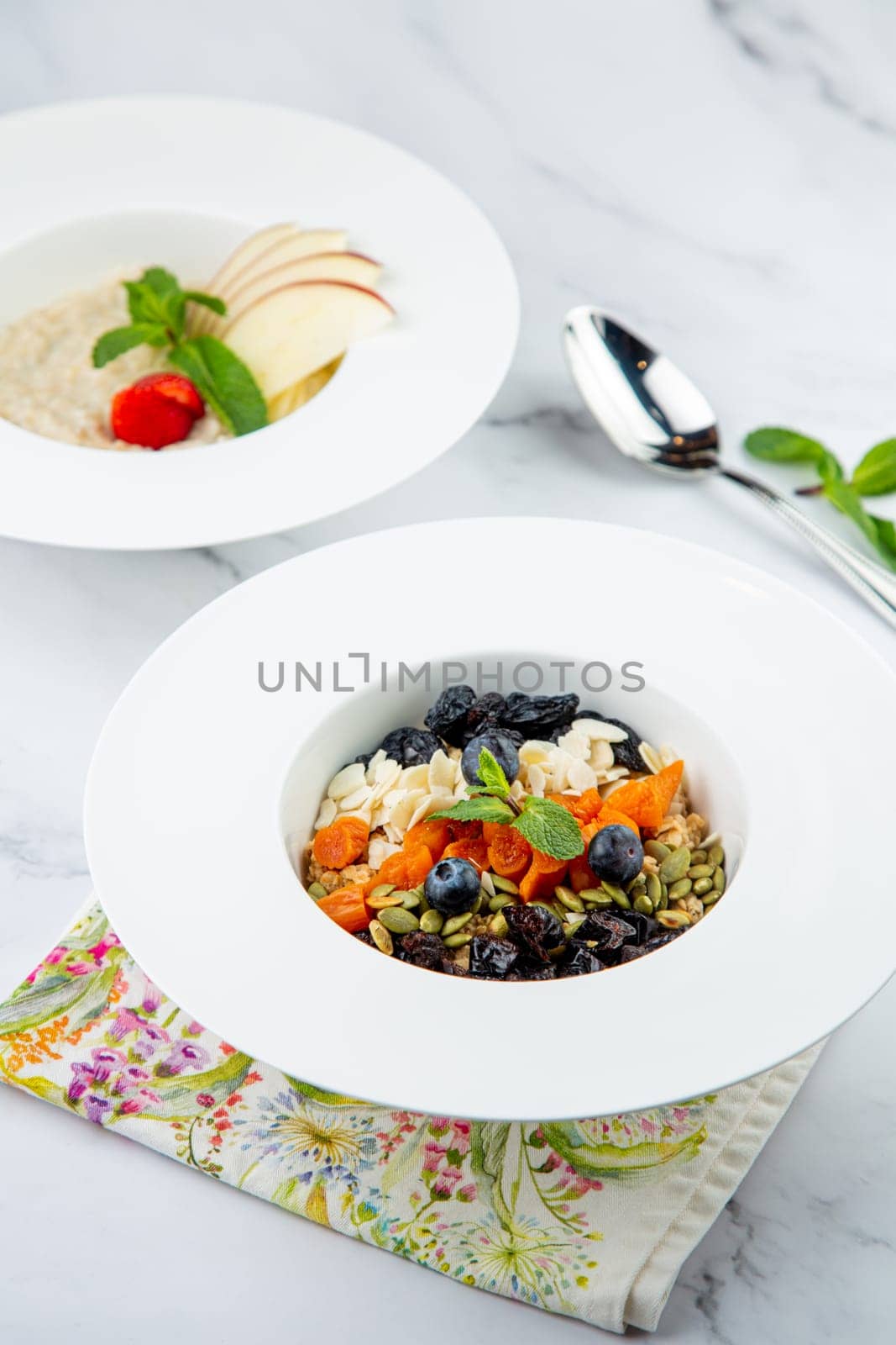 deep plate with cereals, berries, pistachios, dried apricots and raisins