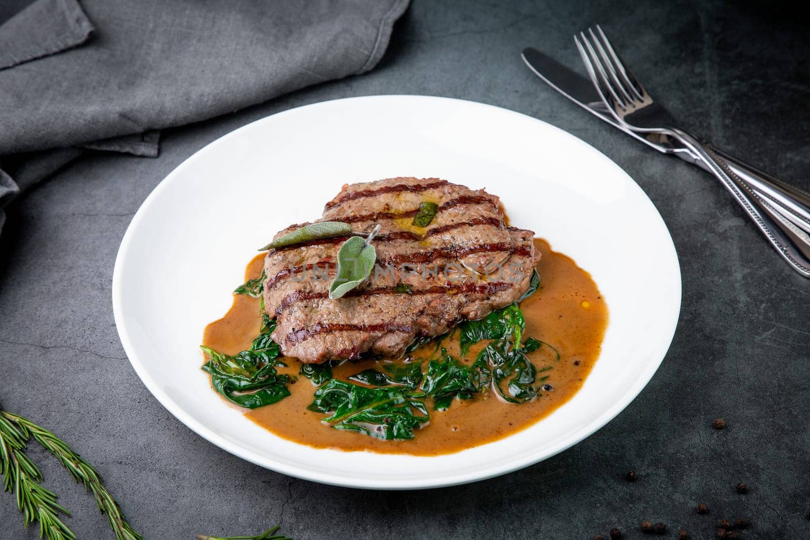 beef steak with gravy and herbs