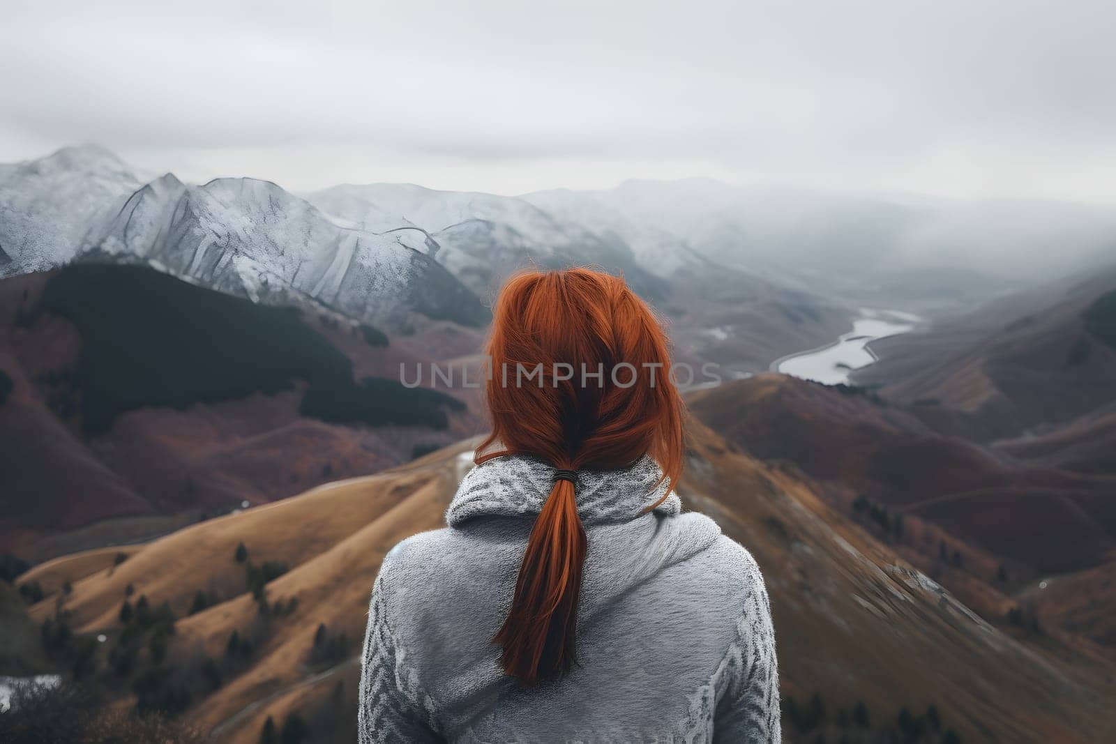 Woman with red hair in grey knitted sweater looking to high mountains landscape, view from back. Neural network generated in May 2023. Not based on any actual person, scene or pattern.