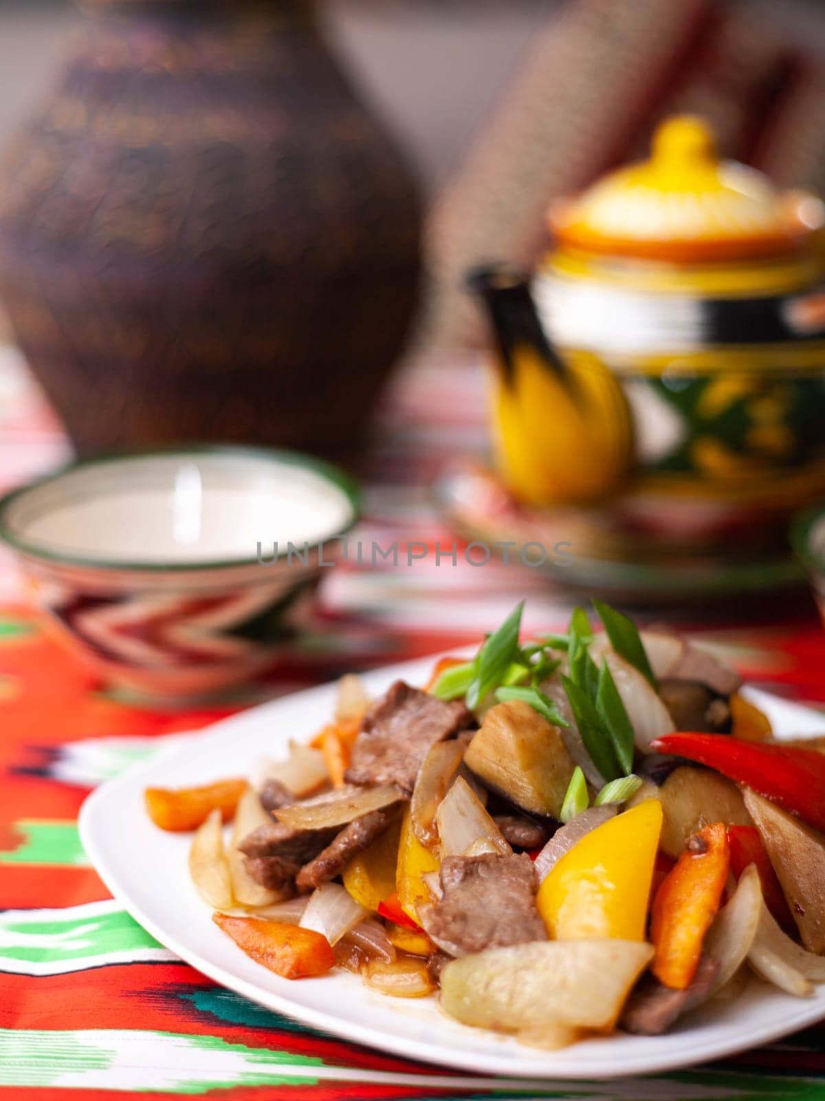 Fried beef meat in oil with potatoes, onions, bell peppers according to the Uyghur recipe. Eastern cuisine, national dish. High quality photo