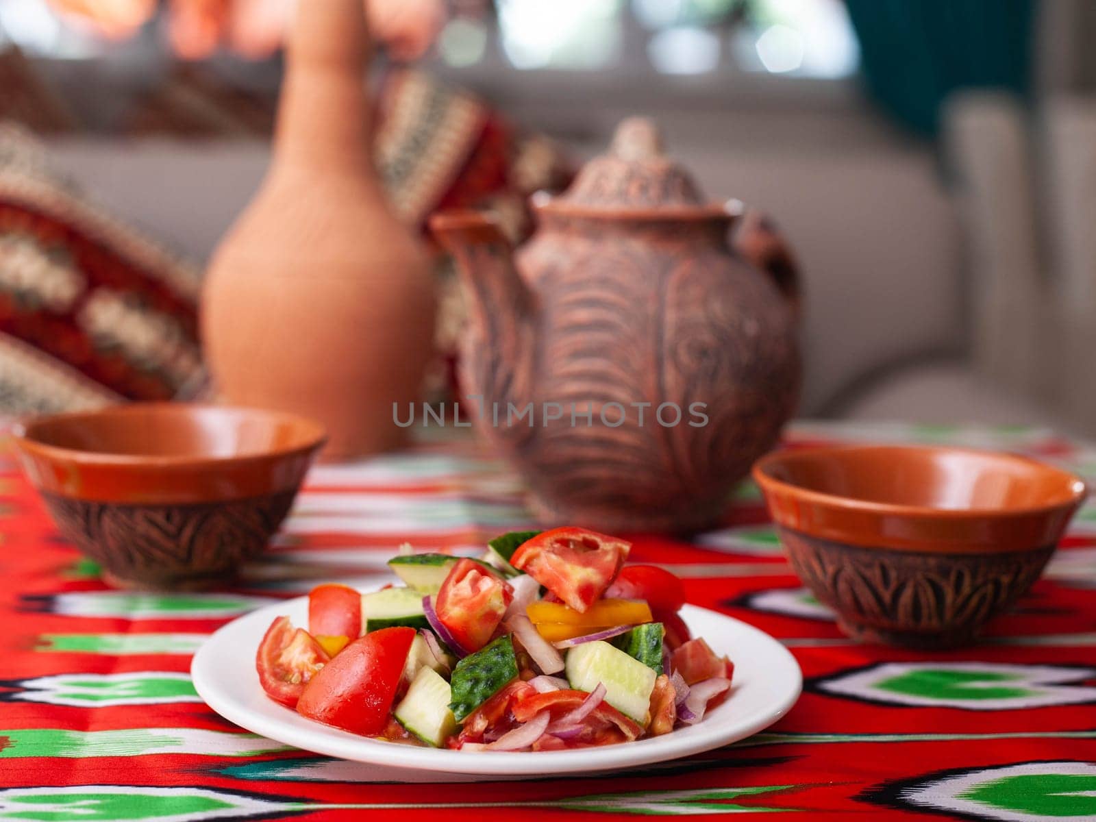 Tomato, cucumber, sweet pepper and onion salad, seasoned with oil. Asian style. High quality photo