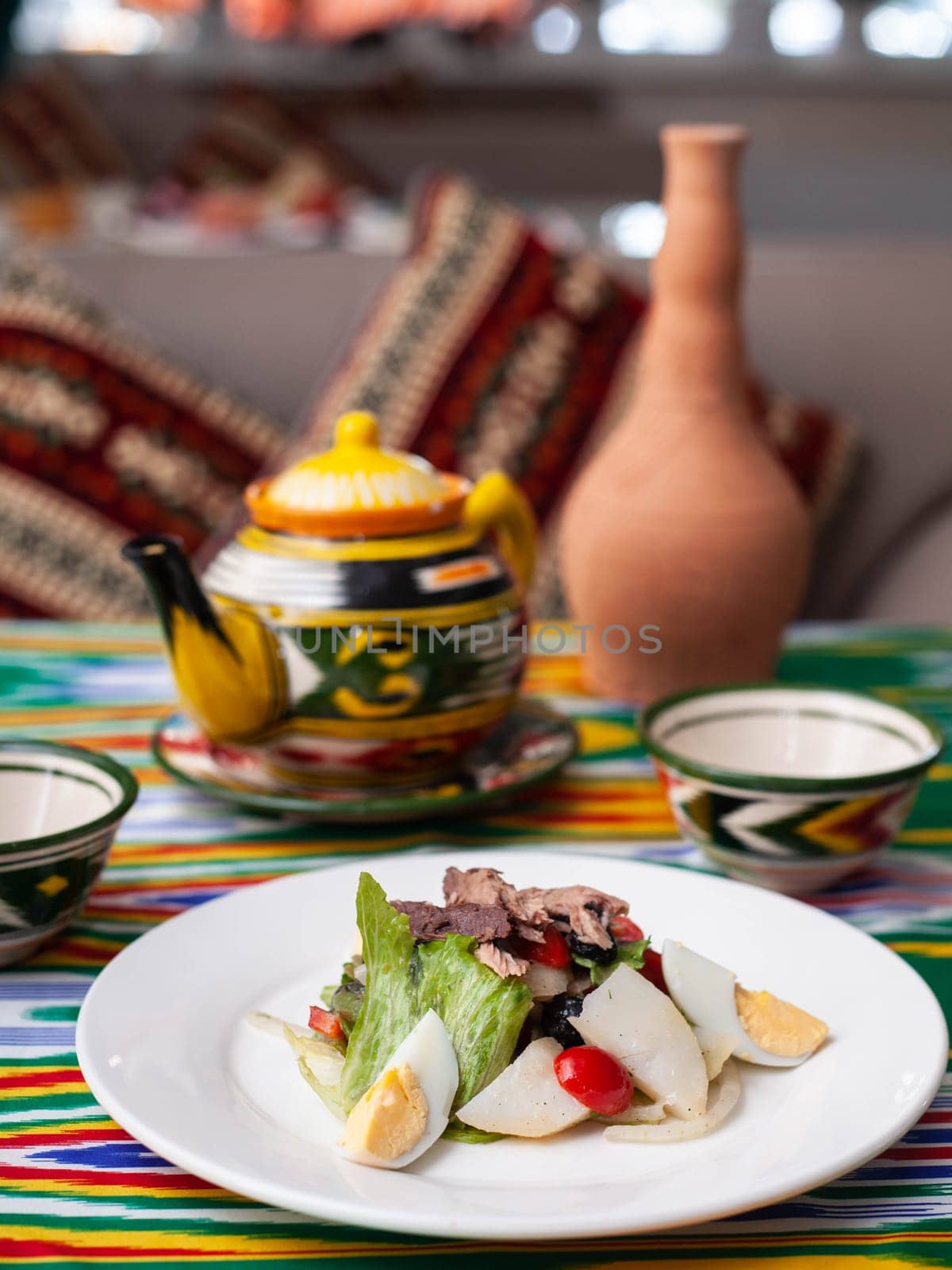 Salad with eggs, herbs, onions, cherry tomatoes, and tuna. Asian style. High quality photo