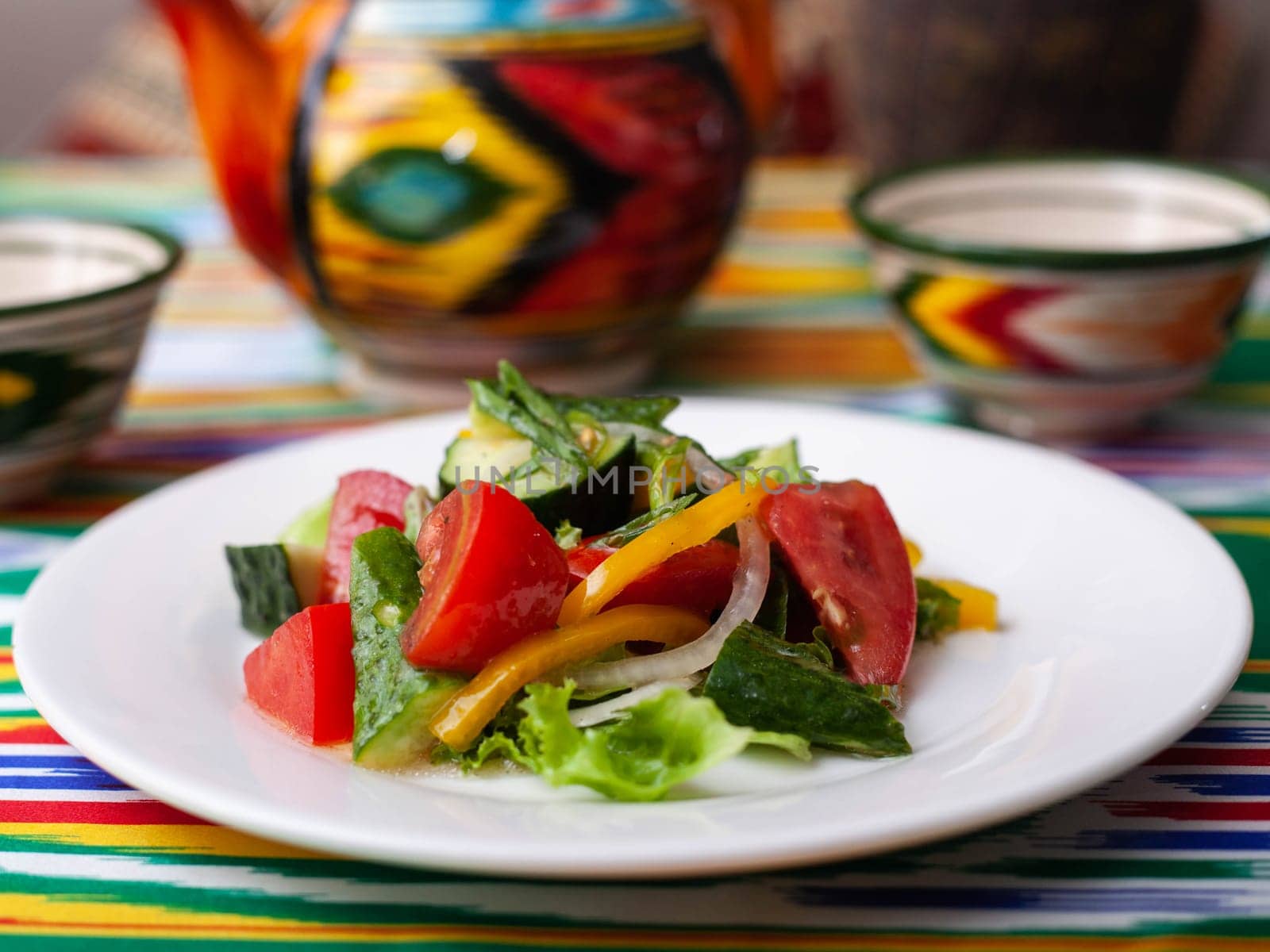 Vegetable salad of tomatoes, cucumbers, herbs and sweet pepper with butter. Asian style. High quality photo