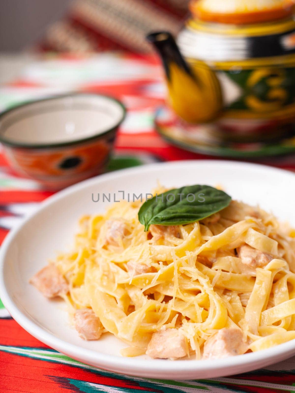 creamy pasta with chicken, basil and mushrooms, according to the Italian recipe. East style by tewolf