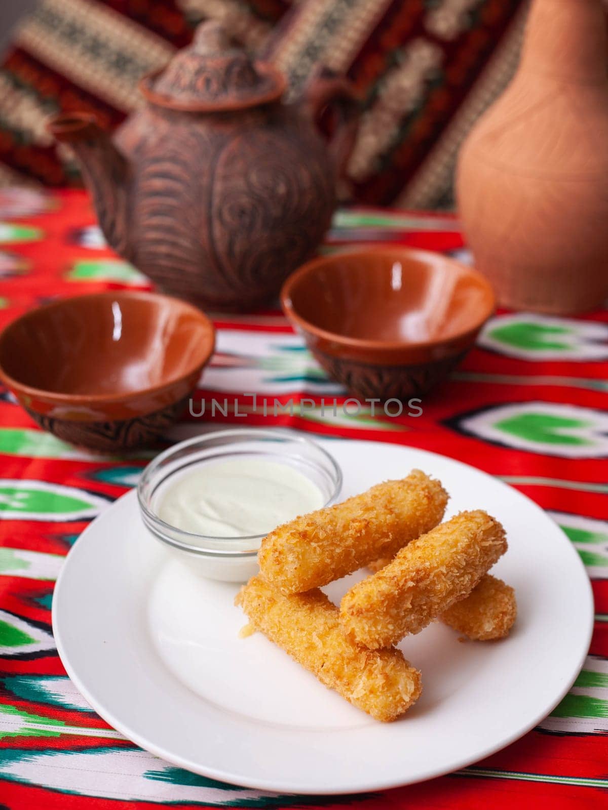 cheese sticks - fried breaded cheese served with creamy sauce. Asian style. High quality photo