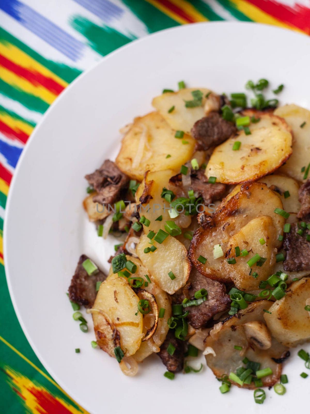 Fried potatoes with pieces of meat. Asian style. High quality photo