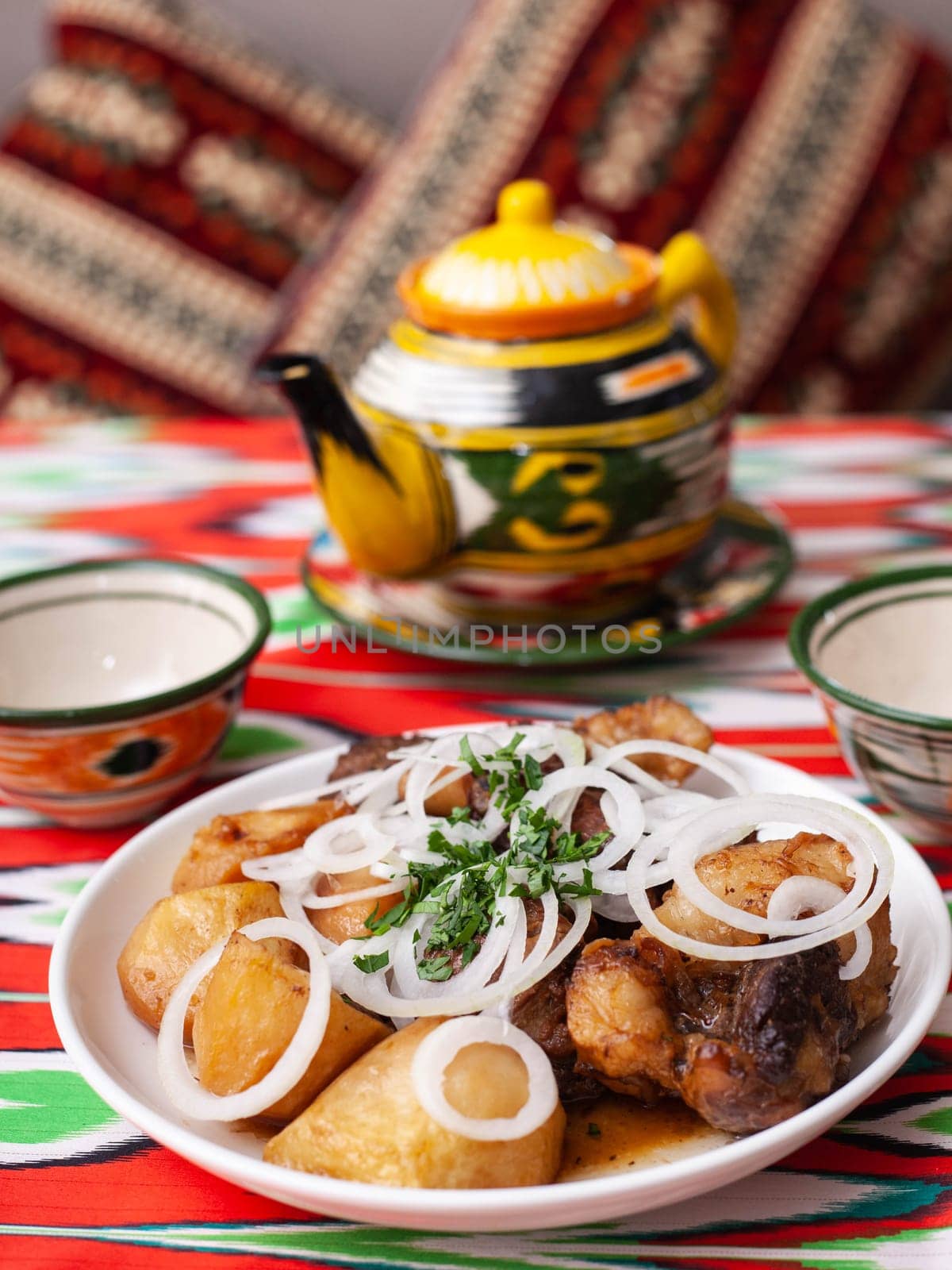 An oriental dish of grilled beef, potatoes and onions with herbs. Asian style. High quality photo