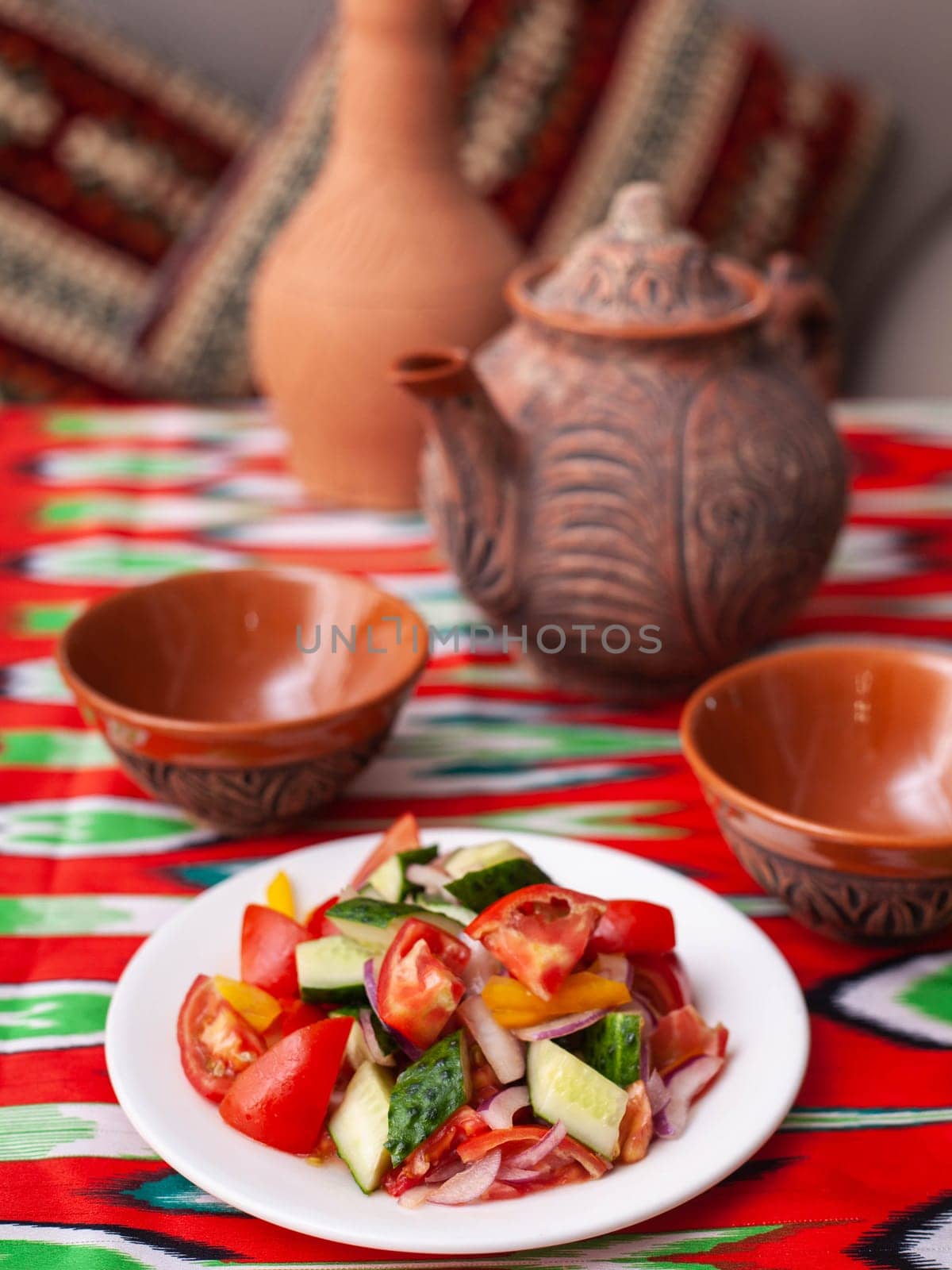 Tomato, cucumber, sweet pepper and onion salad, seasoned with oil. Asian style. High quality photo