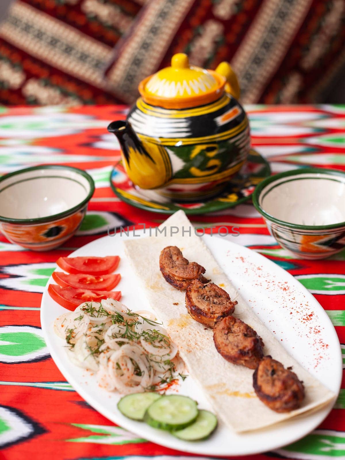 Chicken ifoksr - charcoal grilled chicken breast. Served with vegetables, pickled onions, lavash bread and oriental sauce. Eastern cuisine. High quality photo