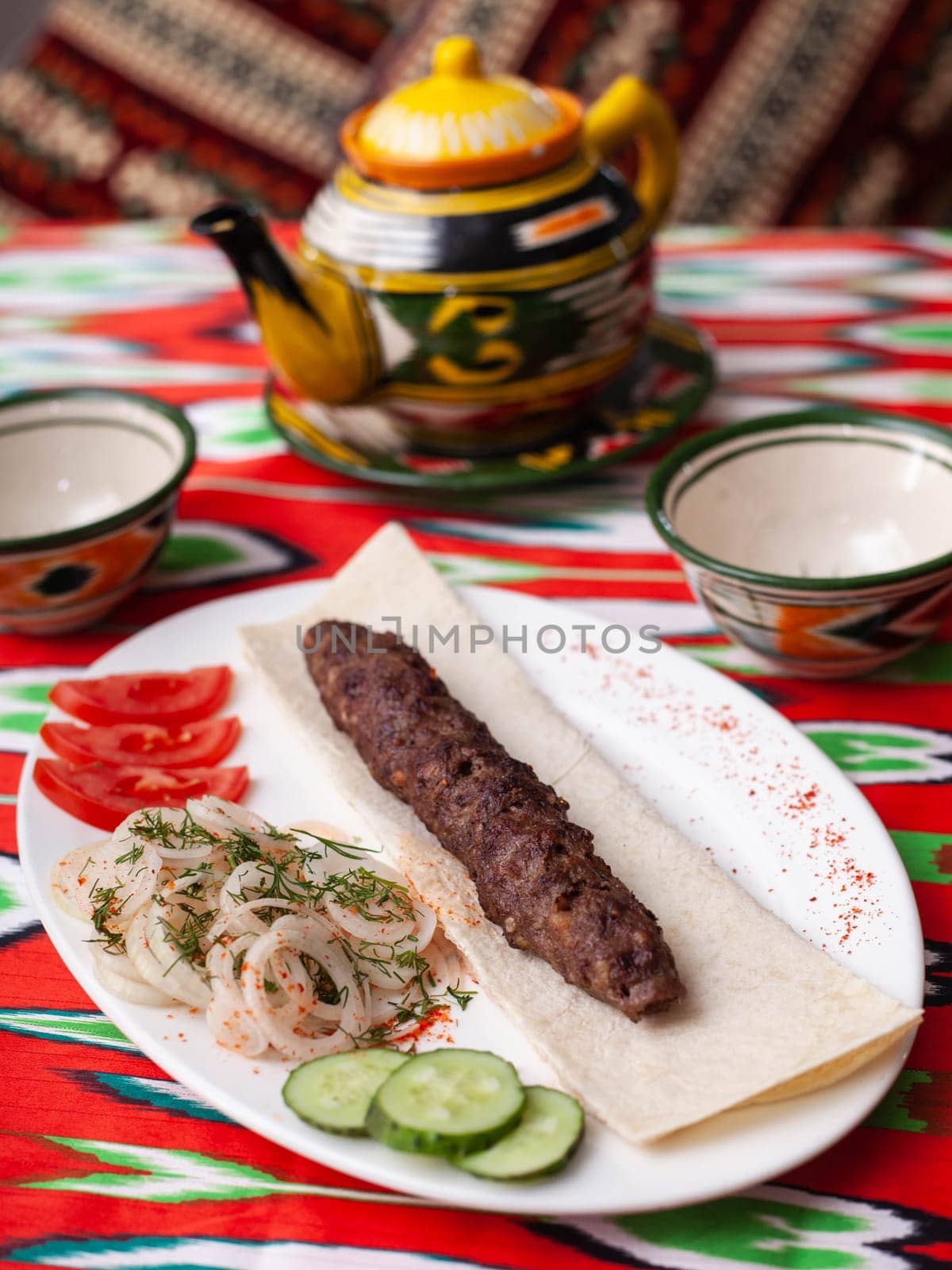 beef and lamb shashlik - grilled meat, minced meat. Served with vegetables, pickled onions, lavash bread by tewolf