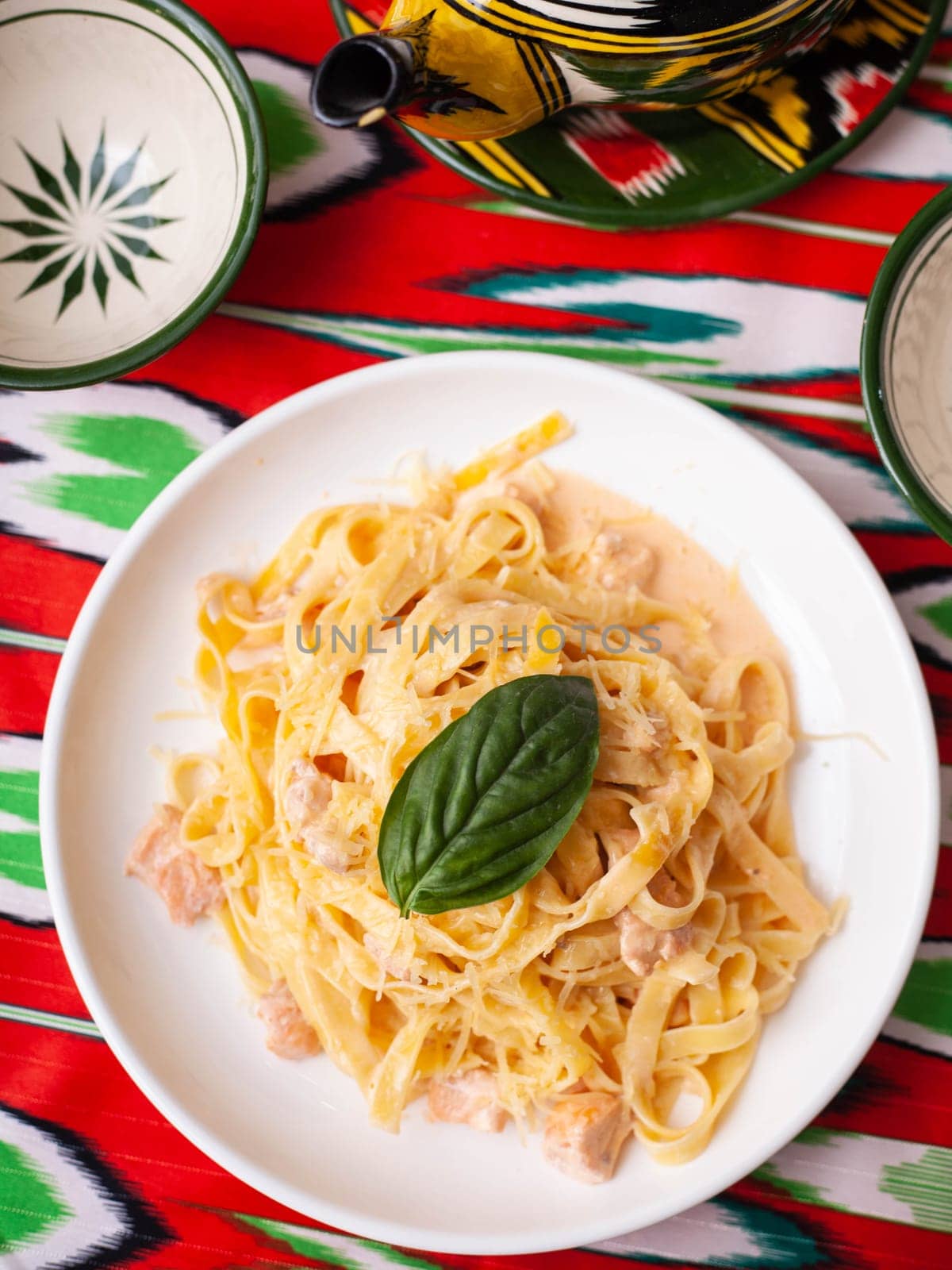 creamy pasta with chicken, basil and mushrooms, according to the Italian recipe. East style. High quality photo