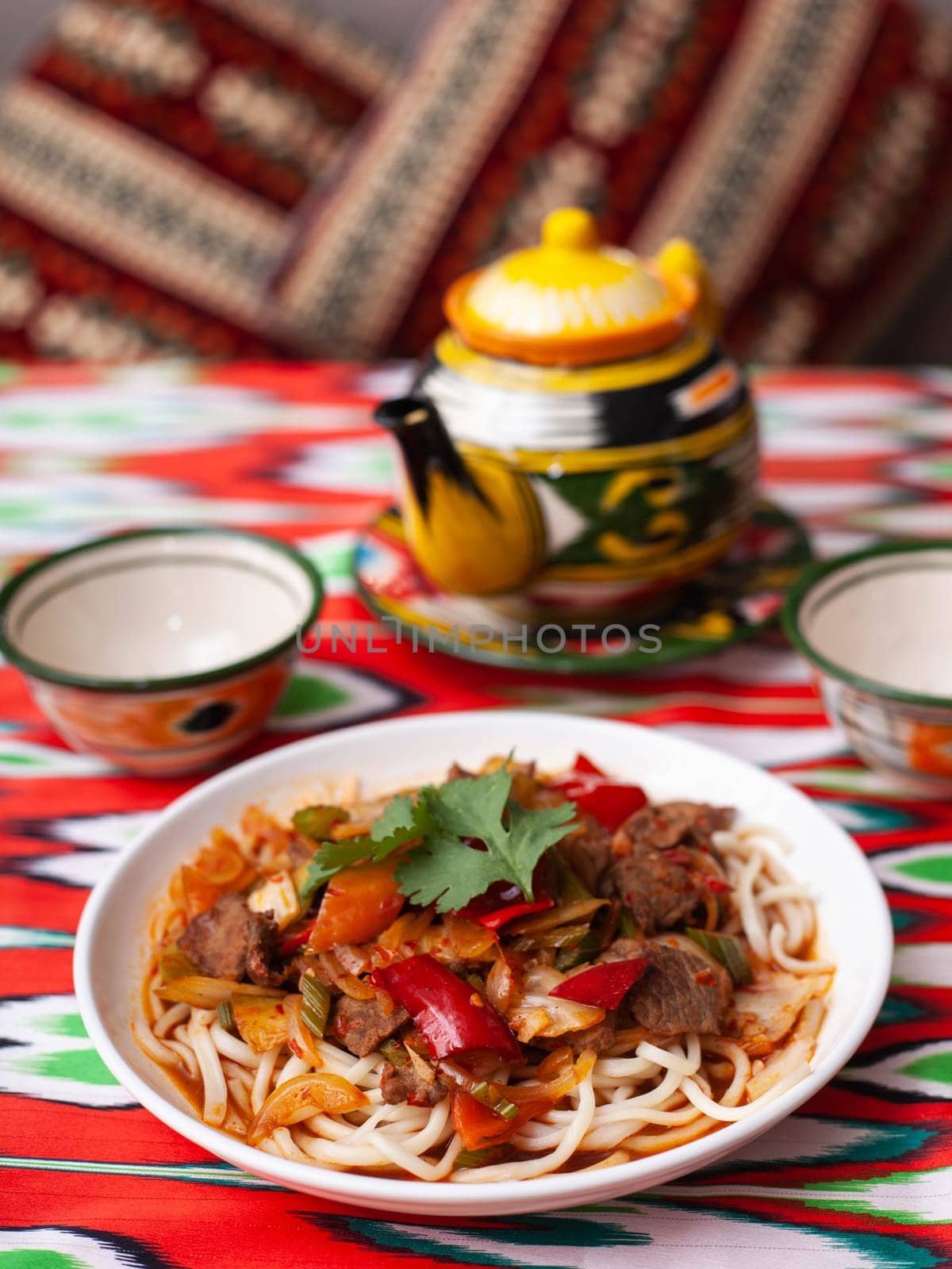 The oriental lagman dish is homemade noodles fried with meat, vegetables and herbs. Eastern cuisine by tewolf