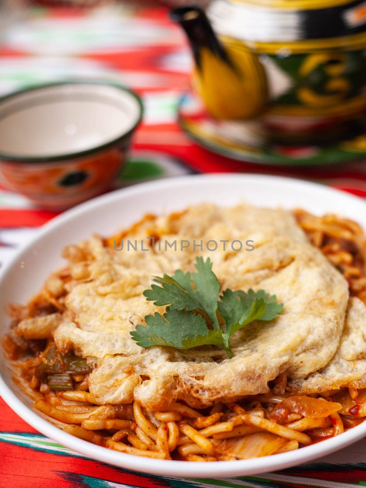 The oriental lagman dish is homemade noodles fried with meat, vegetables and herbs. Eastern cuisine by tewolf