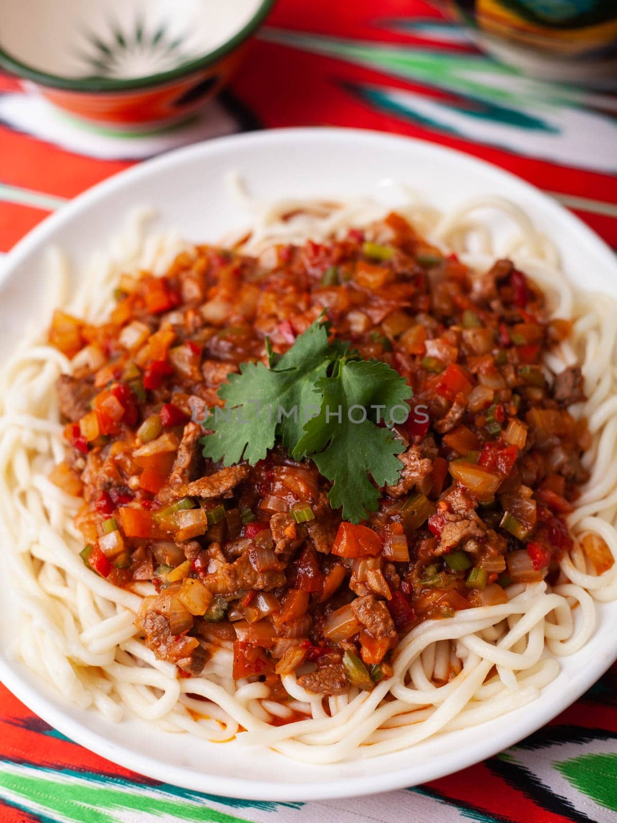 The oriental dish guiru lagman is homemade noodles fried with meat, vegetables and herbs. Eastern cuisine. High quality photo