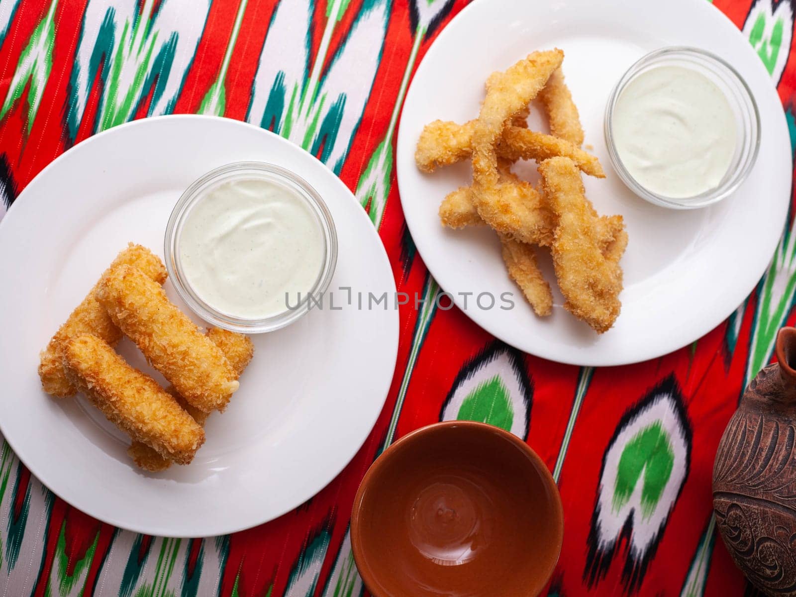 cheese sticks and chicken nuggets - fried cheese and breaded fried chicken served with a creamy sauce. Asian style. High quality photo