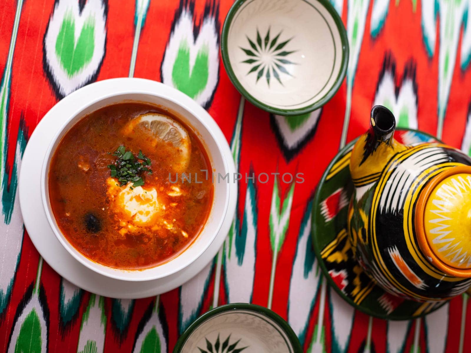 Solyanka. Meat soup made from meat, smoked meats, olives and lemon, served with sour cream. East style by tewolf