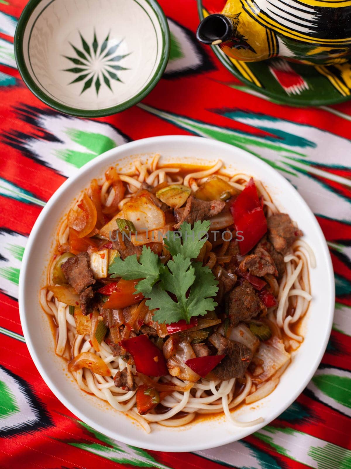 The oriental lagman dish is homemade noodles fried with meat, vegetables and herbs. Eastern cuisine. High quality photo