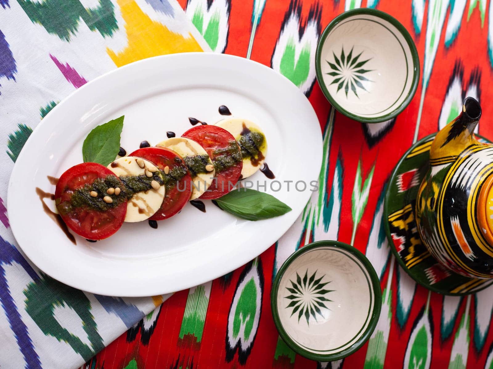 Italian caprese salad with tomatoes, mazzarella cheese and balsamic sauce. Asian style. High quality photo