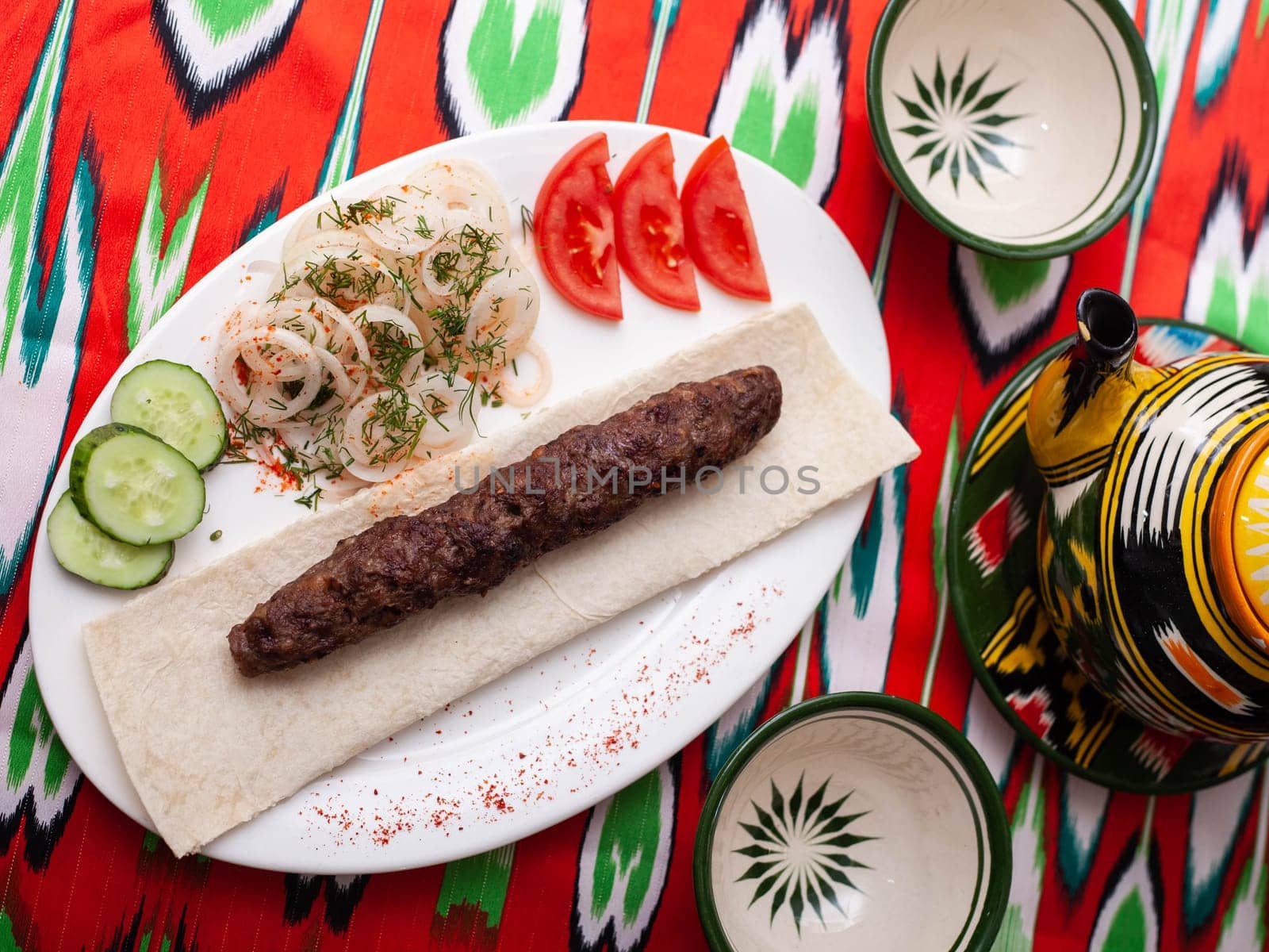 beef and lamb shashlik - grilled meat, minced meat. Served with vegetables, pickled onions, lavash bread and an oriental sauce. Eastern cuisine. High quality photo