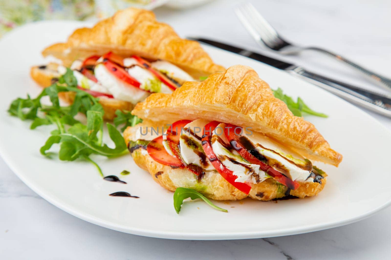 croissants with cheese, vegetables, cherry tomatoes and herbs by tewolf