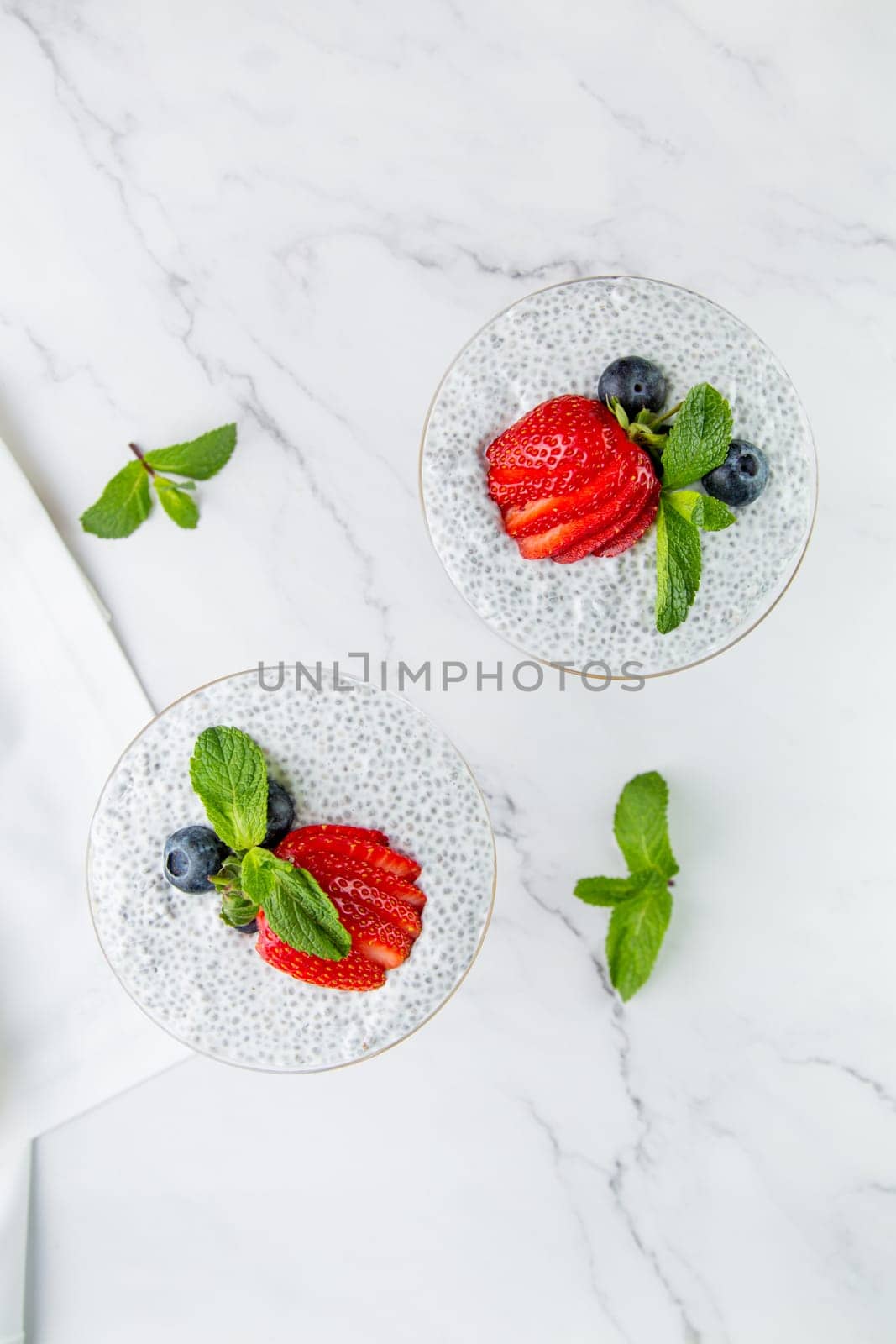 exotic fruit cocktails with berries and chia seed topping and mint top view by tewolf