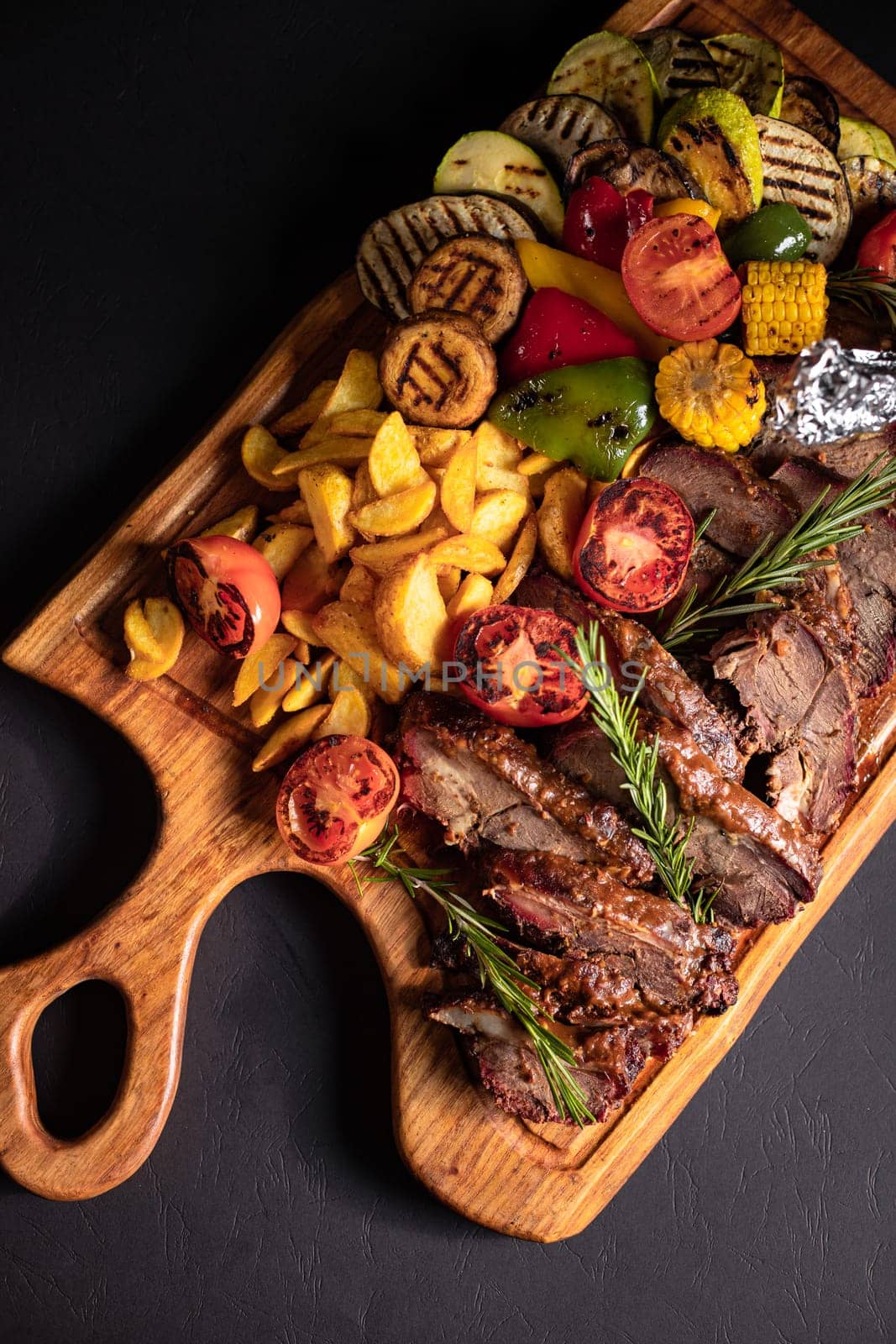 fried pieces of steak with vegetables on the grill