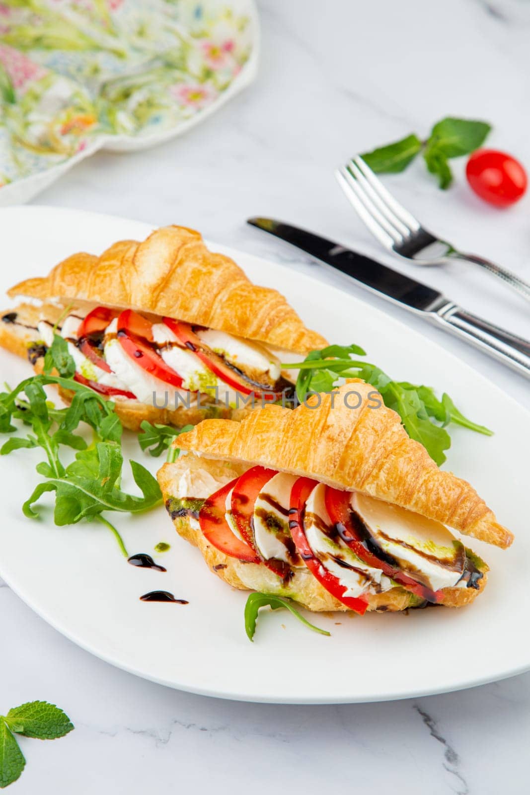 croissants with cheese, vegetables, cherry tomatoes and herbs by tewolf