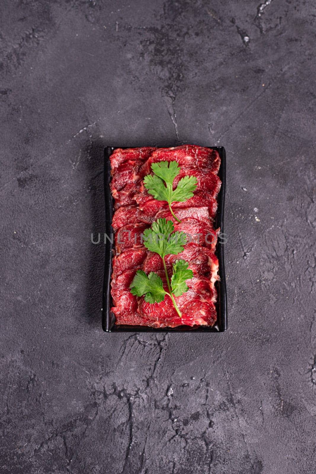 raw beef with green parsley.Garnish. View from above. Chinese cuisine, hotpot ingredient