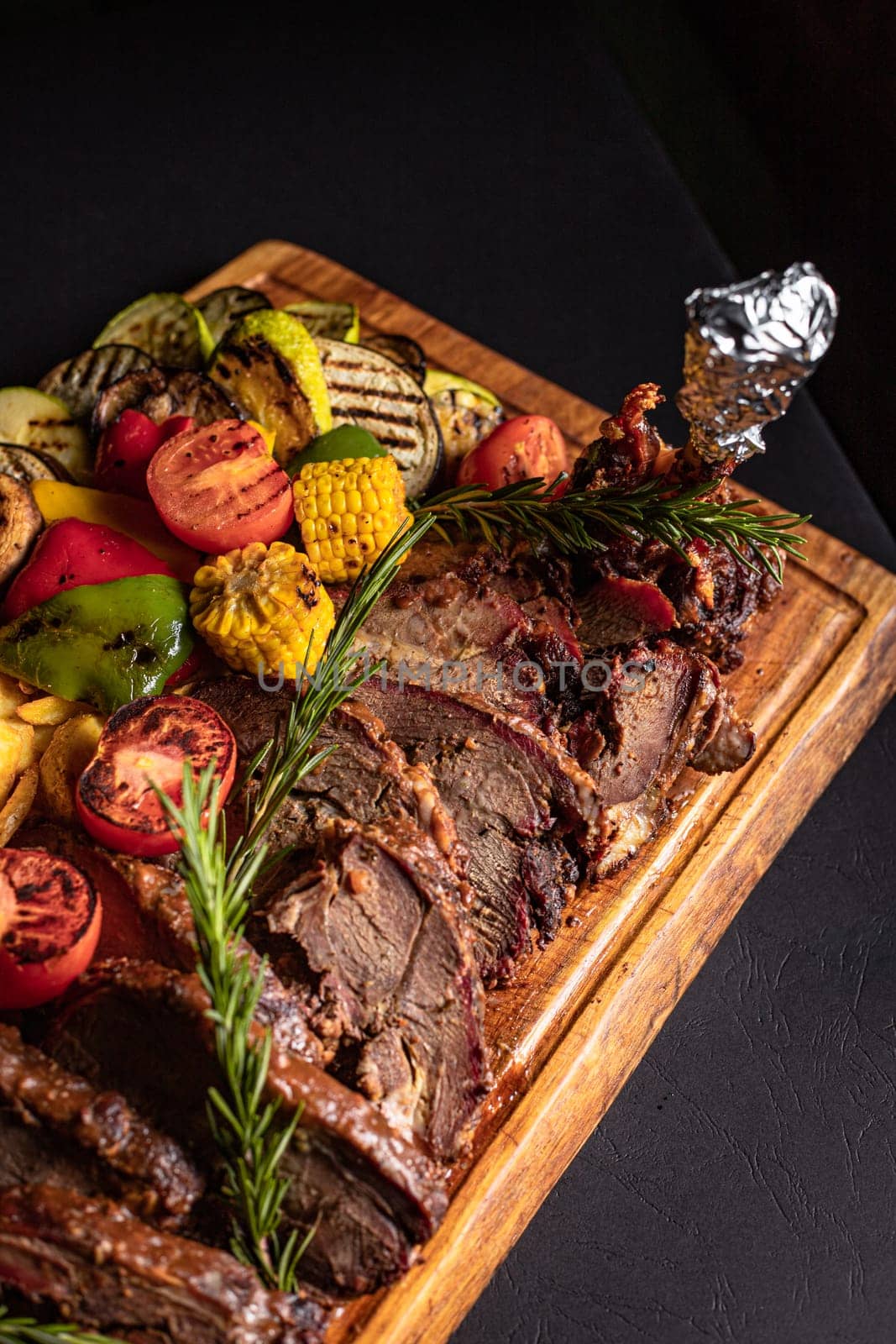 fried pieces of steak with vegetables on the grill