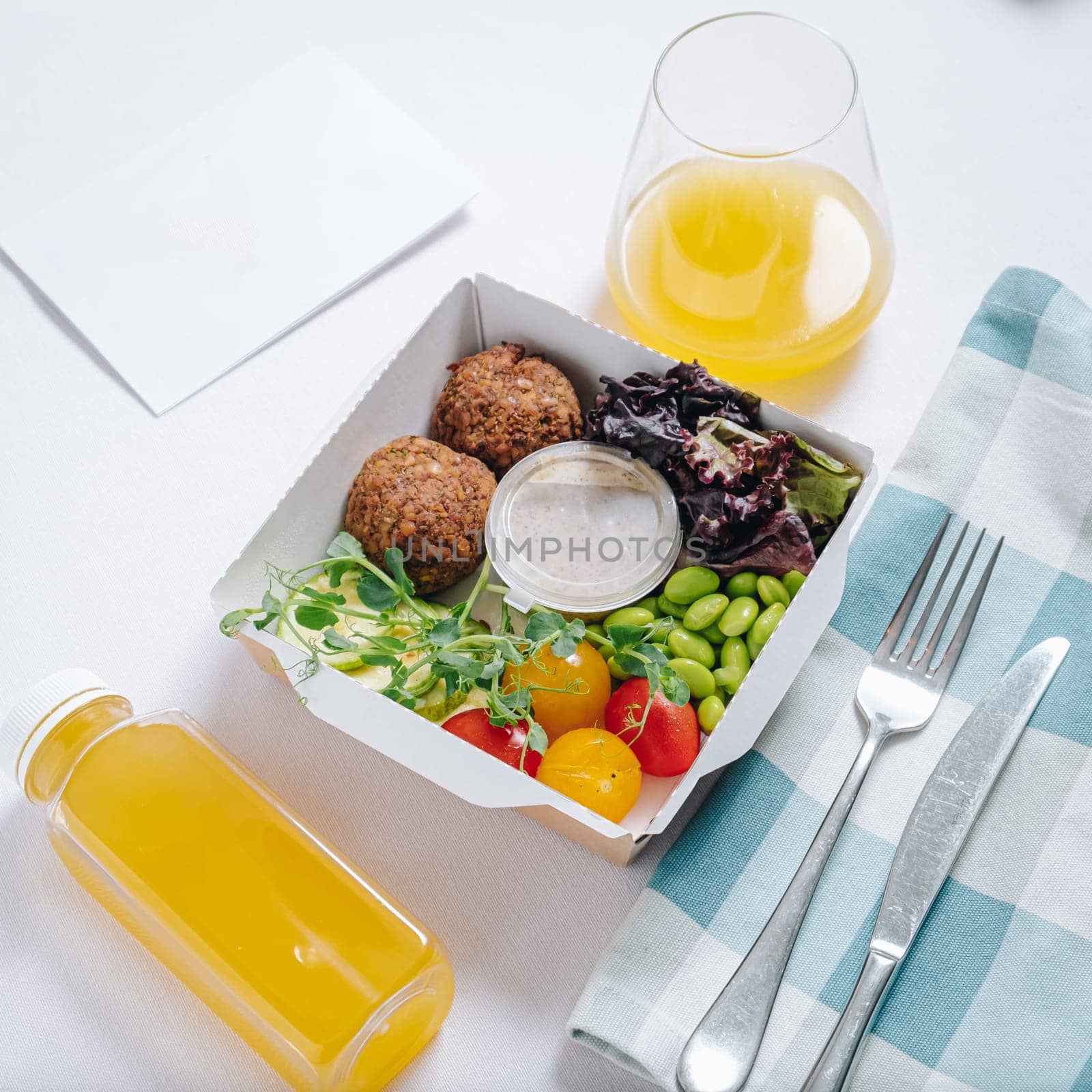 bowl in Chinese style.meatballs with beans, herbs, cherry tomatoes and sauce in a container by tewolf