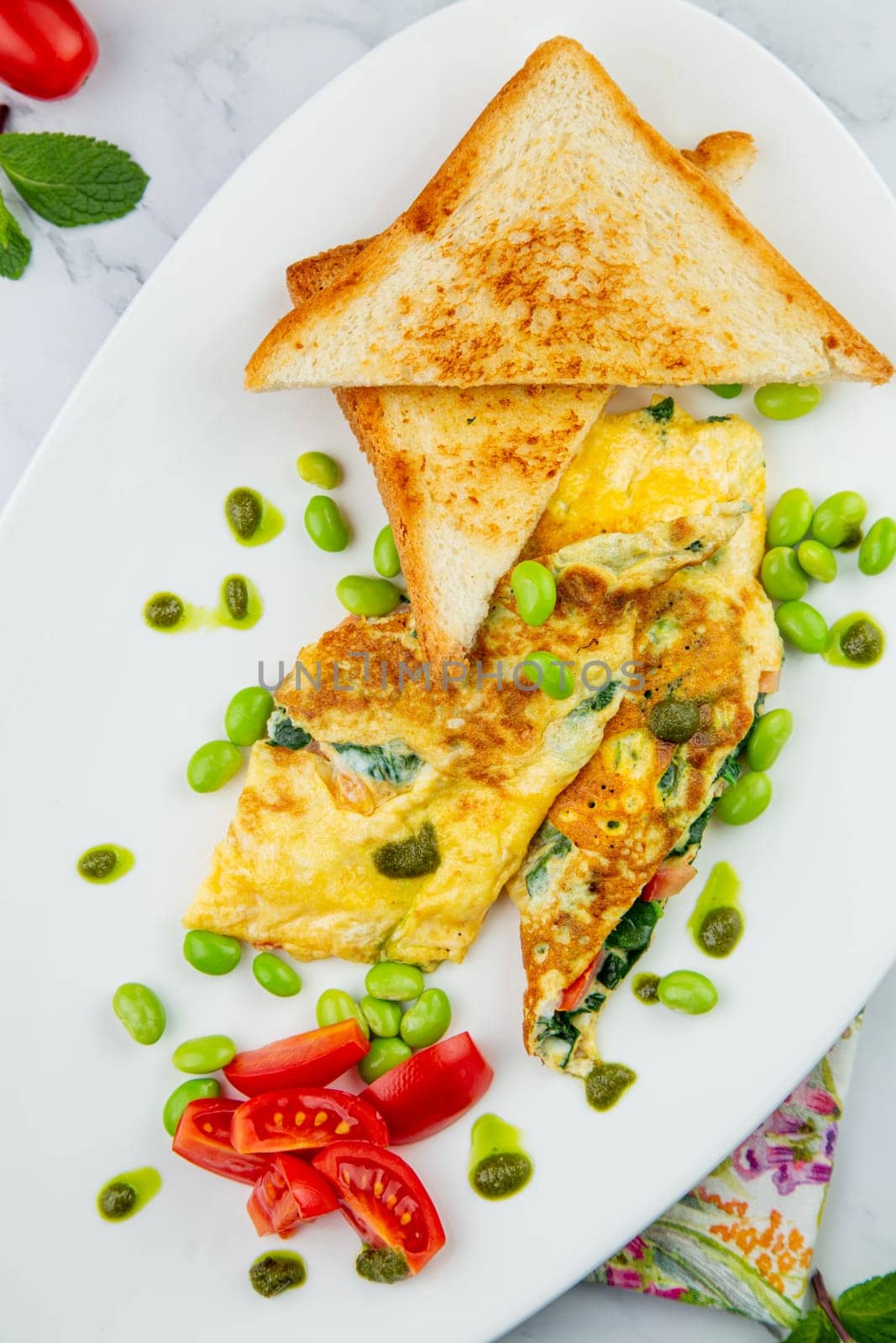 Breakfast of eggs and vegetables with cherry tomatoes and slices of bread