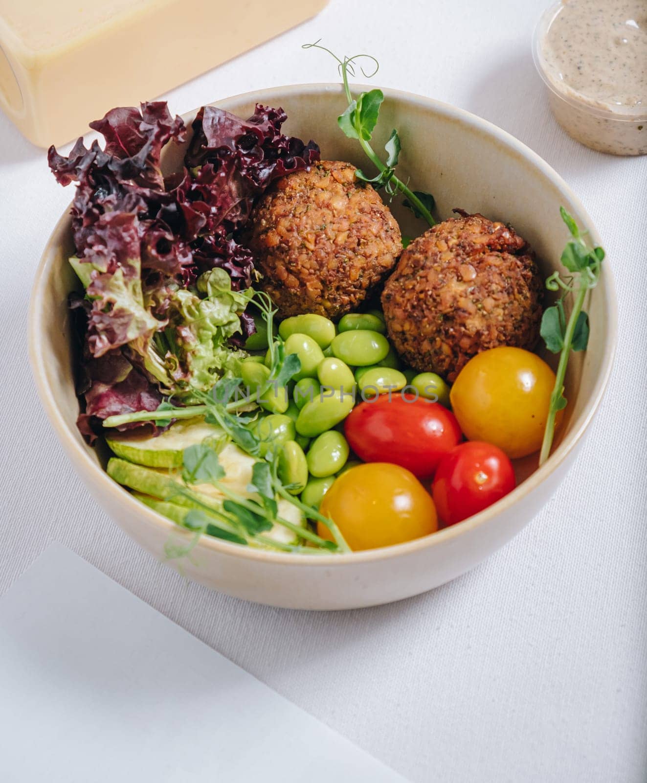 meatballs with beans, herbs, cherry tomatoes and sauce