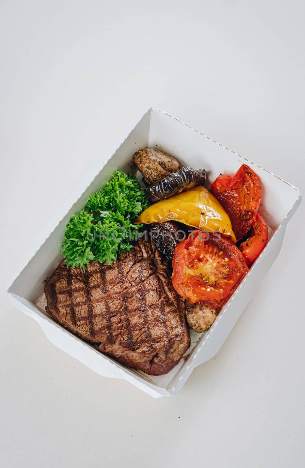 food in containers. proper nutrition, daily diet, weight loss. veal steak with grilled vegetables.