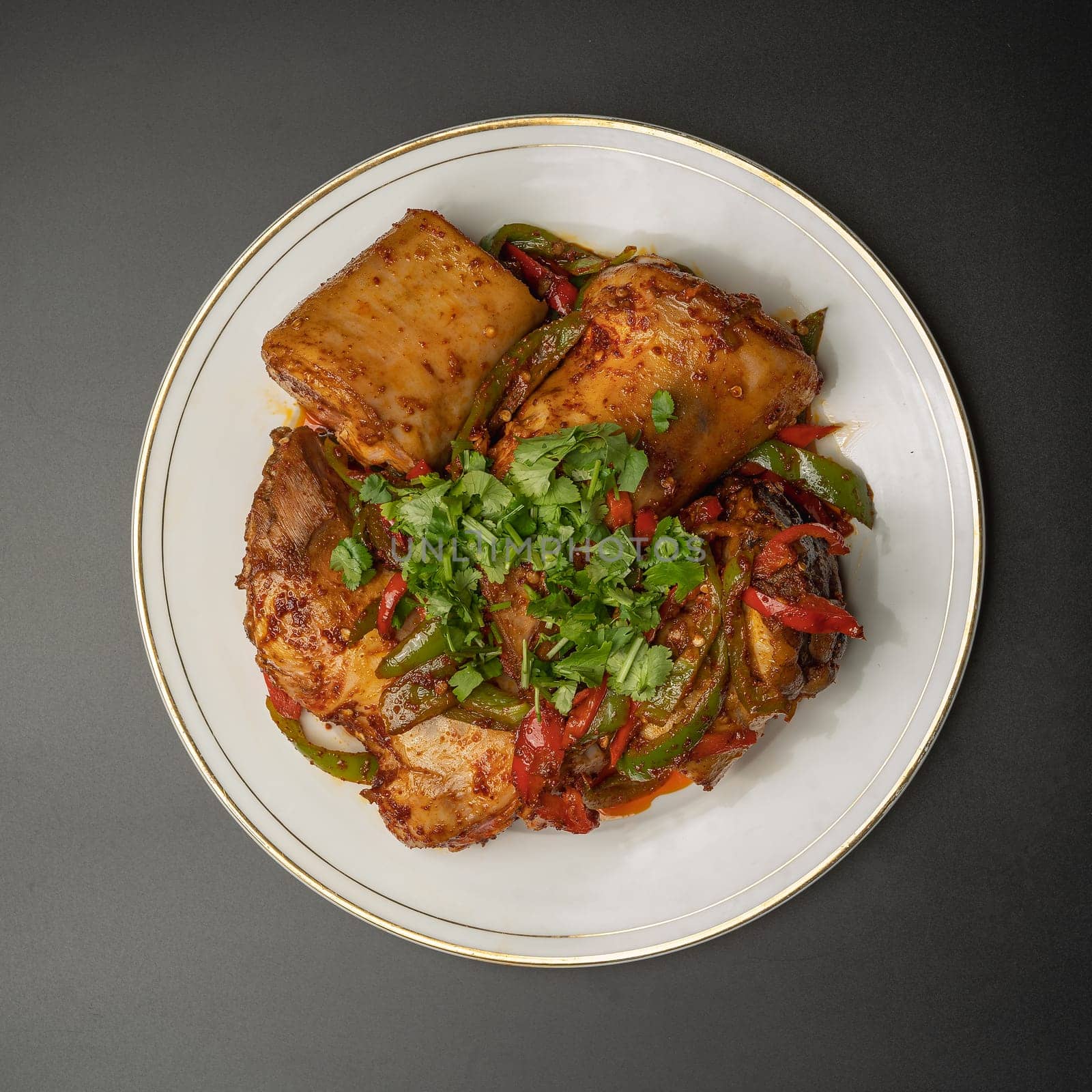 Boiled beef legs with spices and herbs on a white plate by tewolf