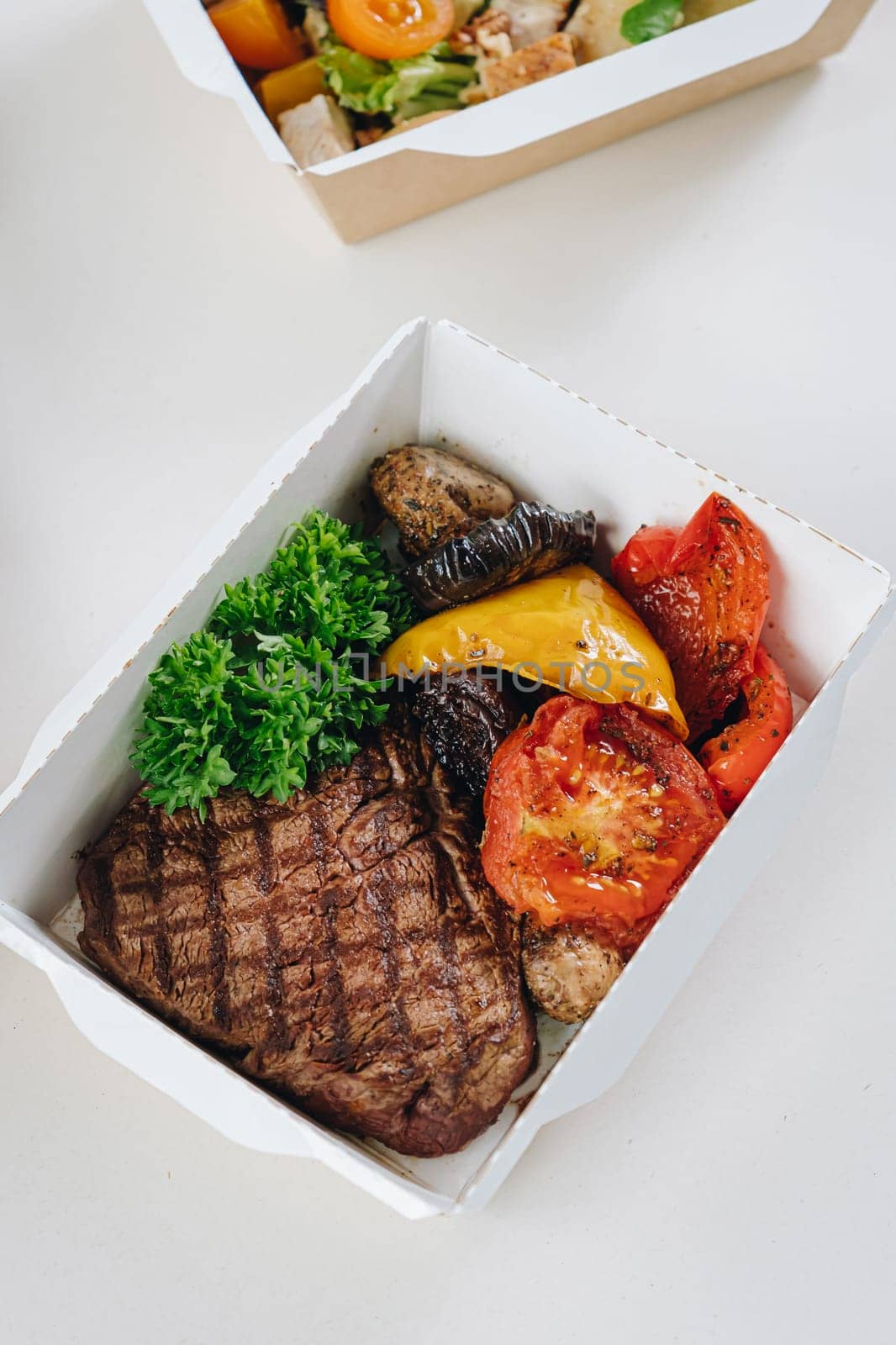 food in containers. proper nutrition, daily diet, weight loss. veal steak with grilled vegetables.