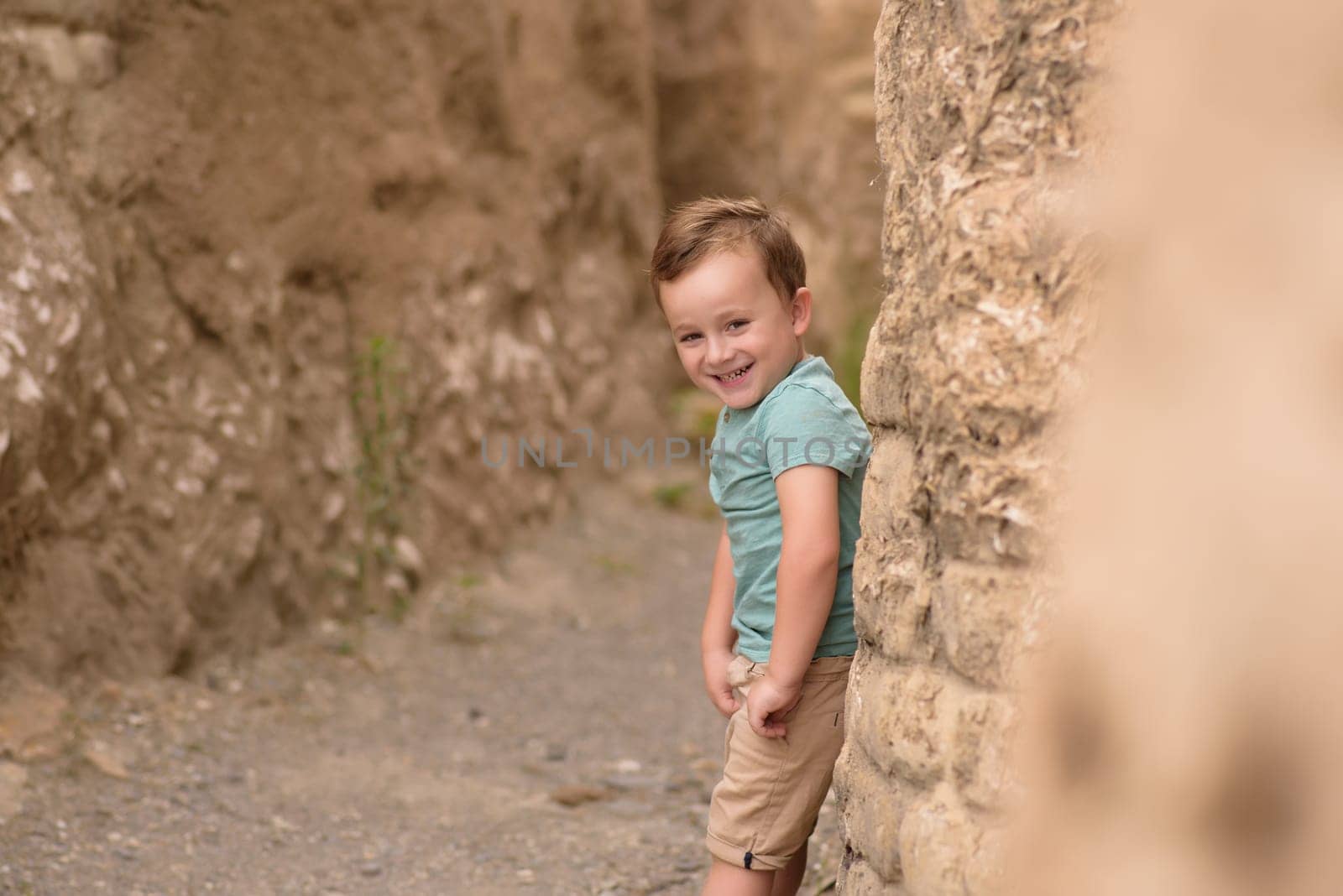 Smiling boy exploring in woods.